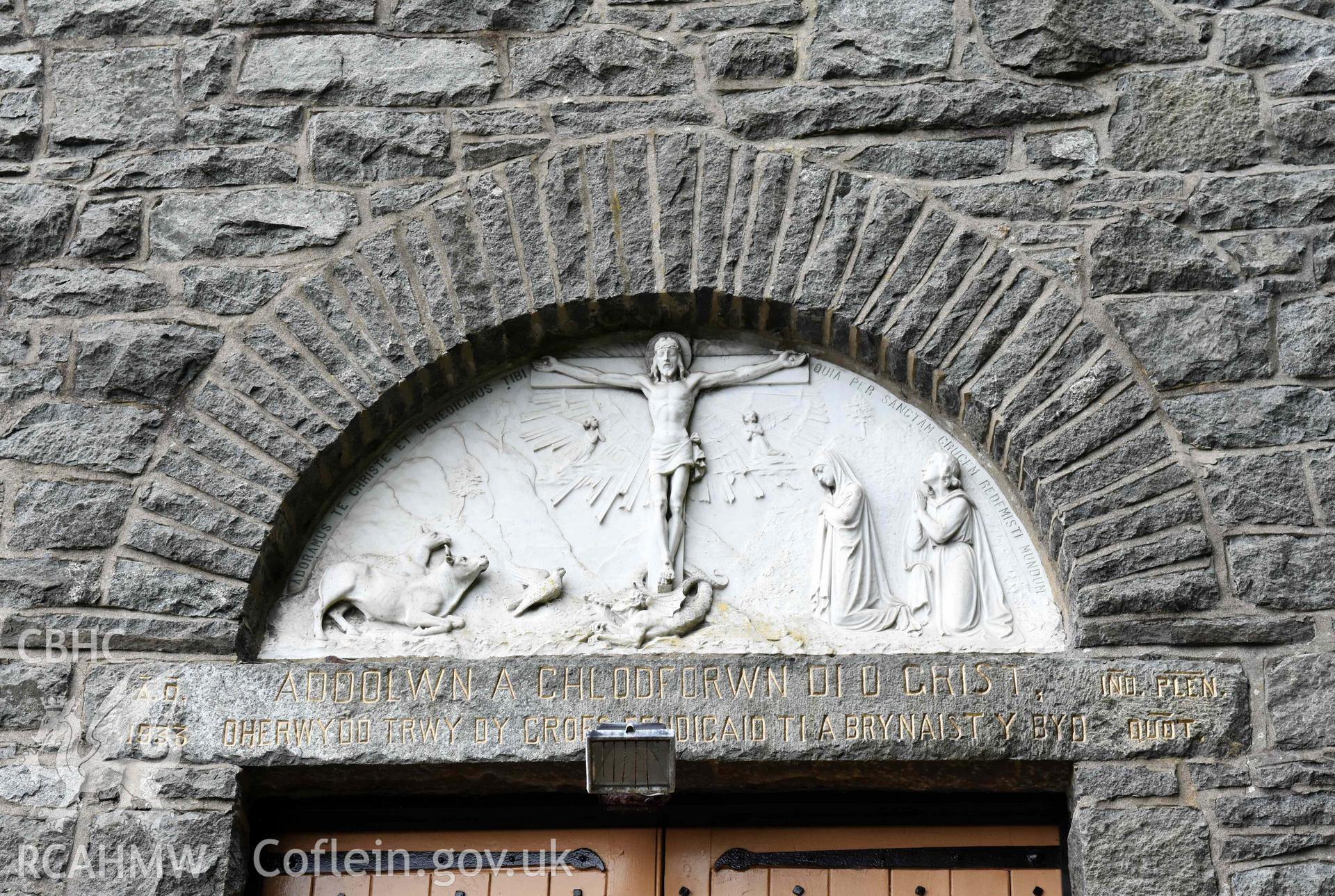 Catholic Church of The Most Holy Redeemer, exterior detail of plasterwork over doorway in north façade