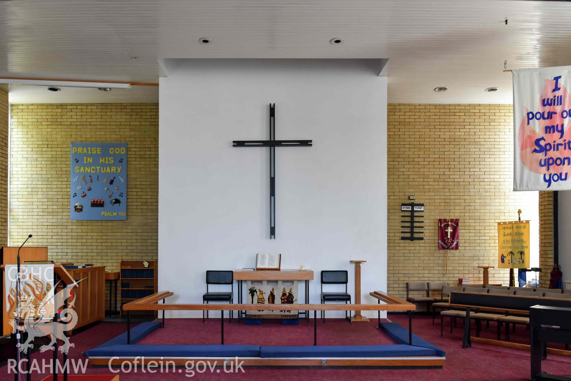 Cyncoed Methodist Church, interior auditorium detail of east end sedd fawr dias with communium table and cross