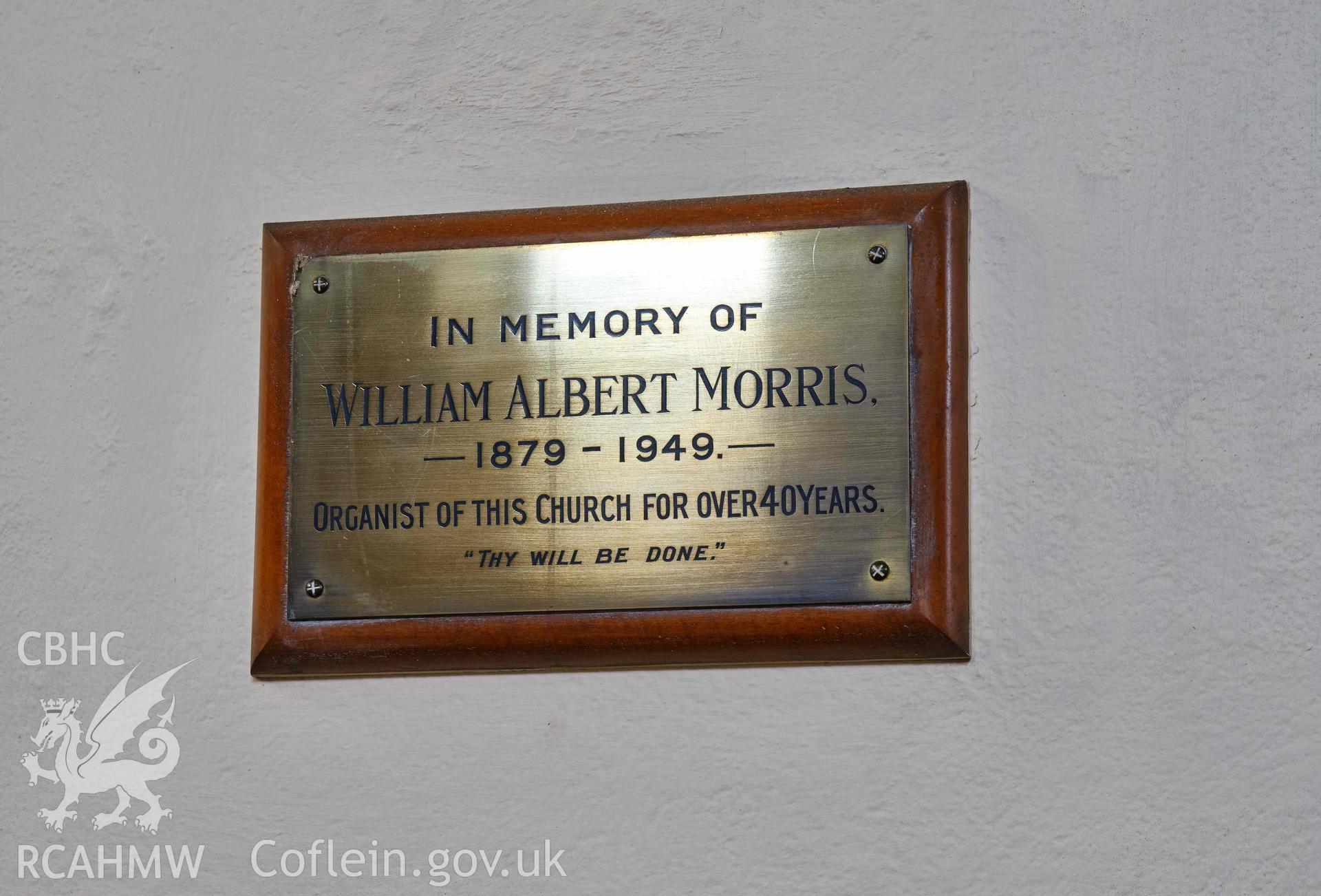 brass commemorative plaque on the NE wall