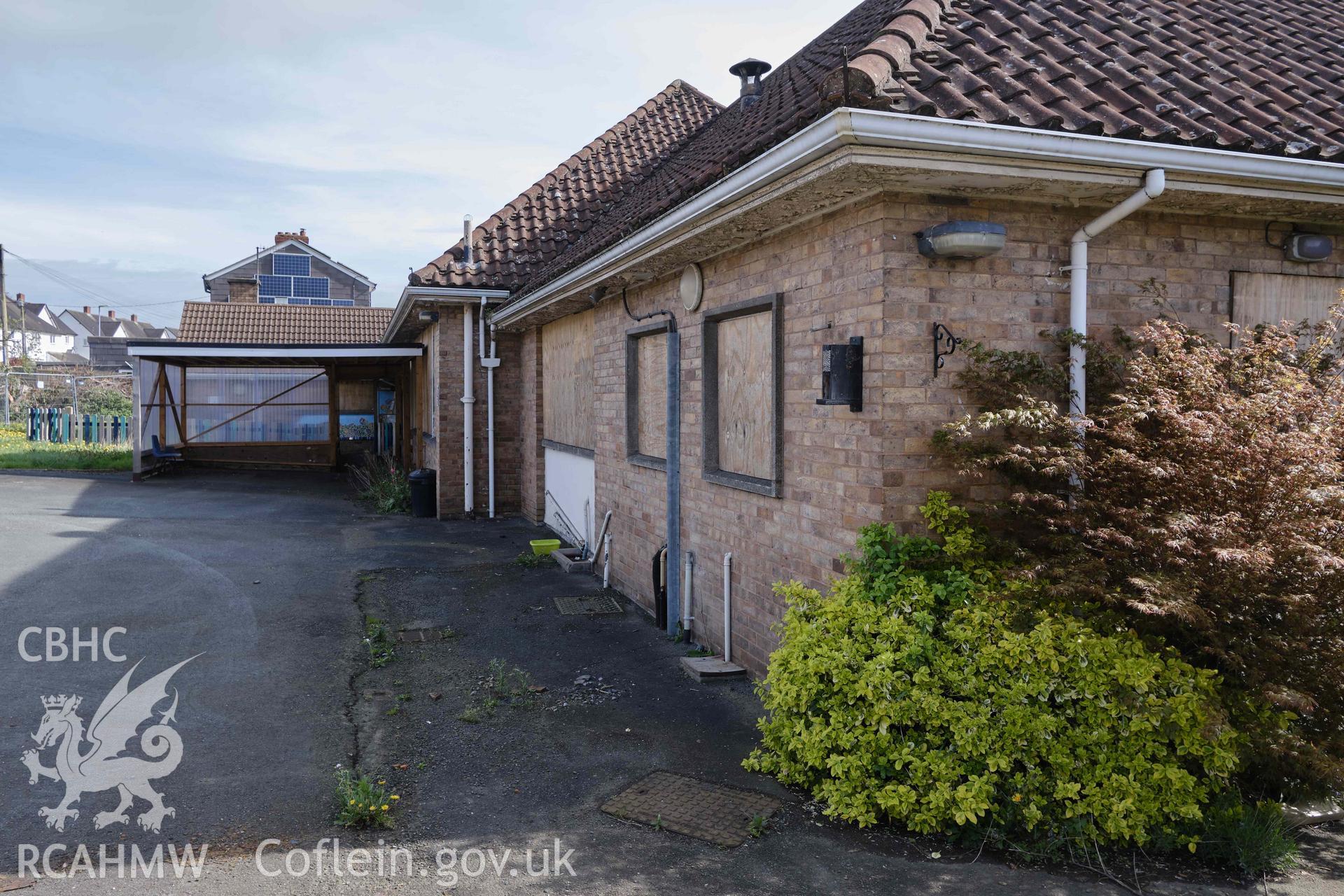 NW front, with hipped roofs and projecting eaves, looking E