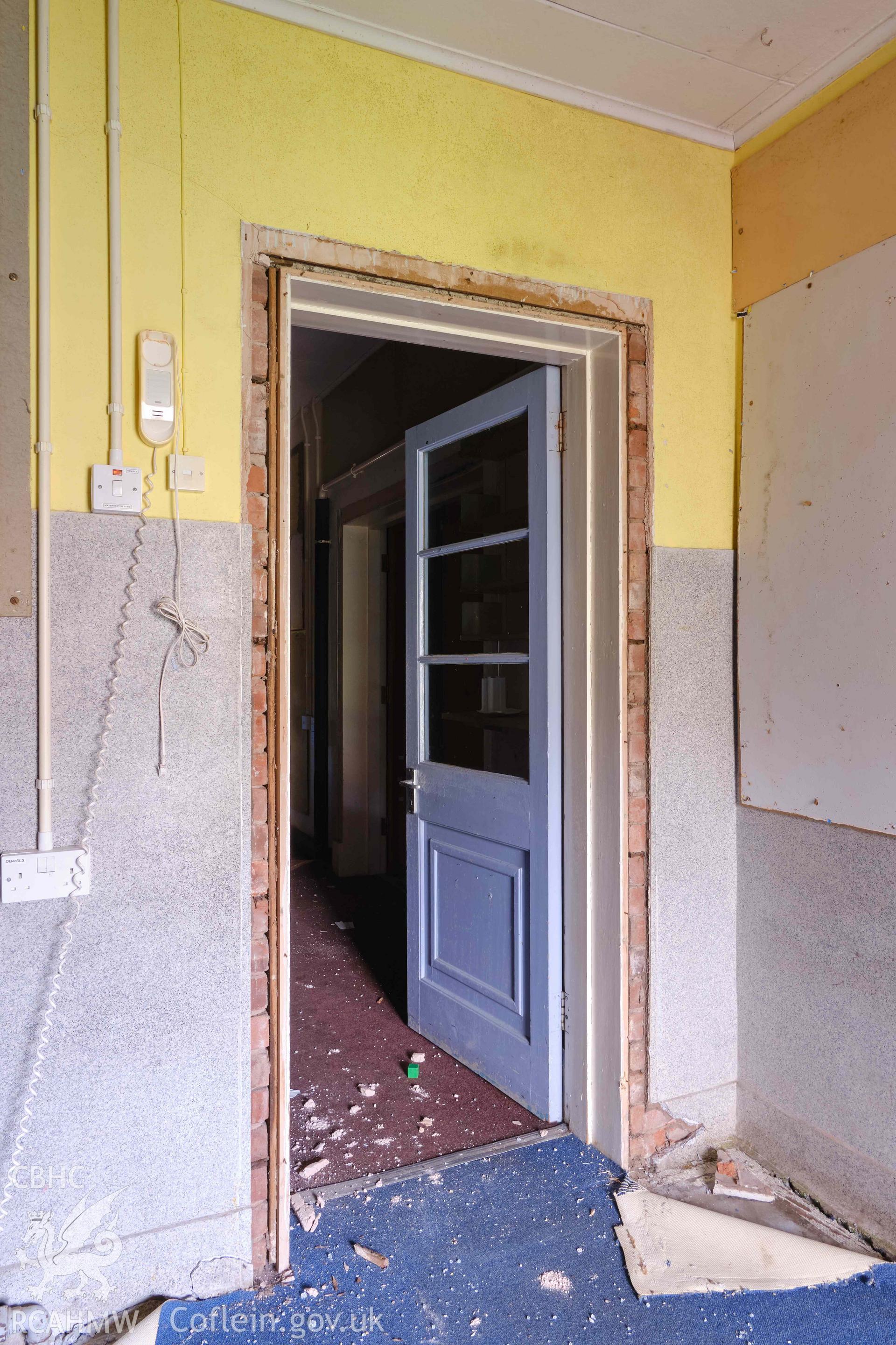 door from entrance lobby to assembly hall/dining room, looking W