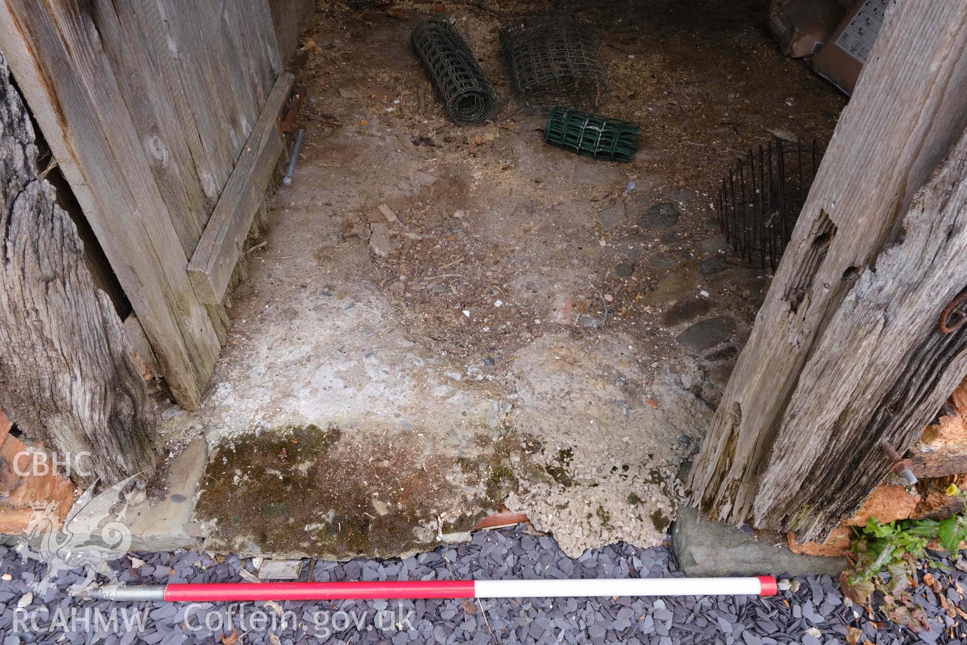 concrete floor at entrance to unit 2, looking N