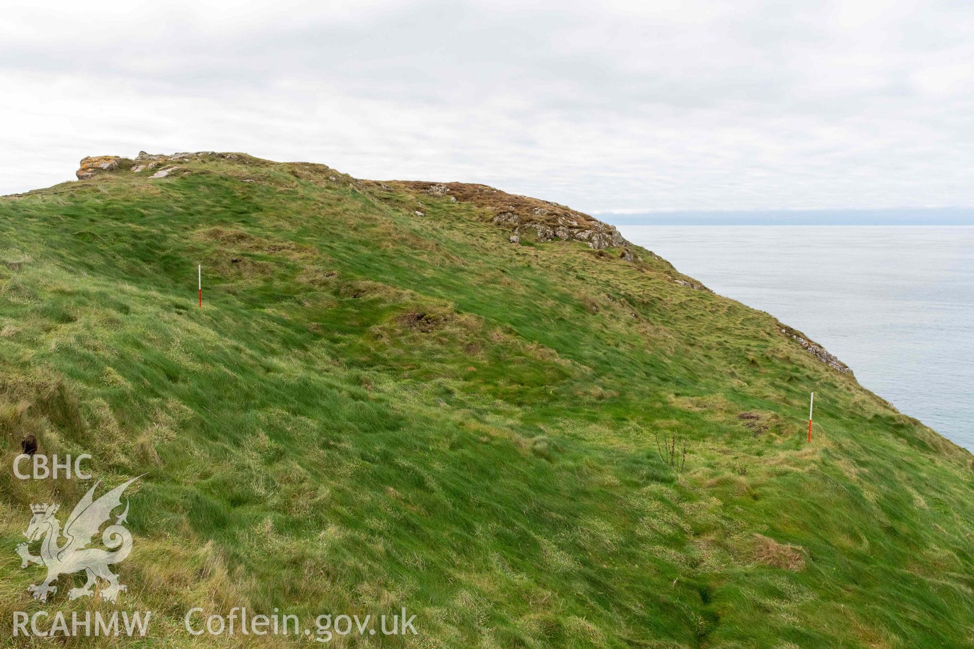 Trwyn Castell coastal promontory fort. Substantial rectangular platform (house platfrom or quarrying) on the north side of the fort interior (with scale).