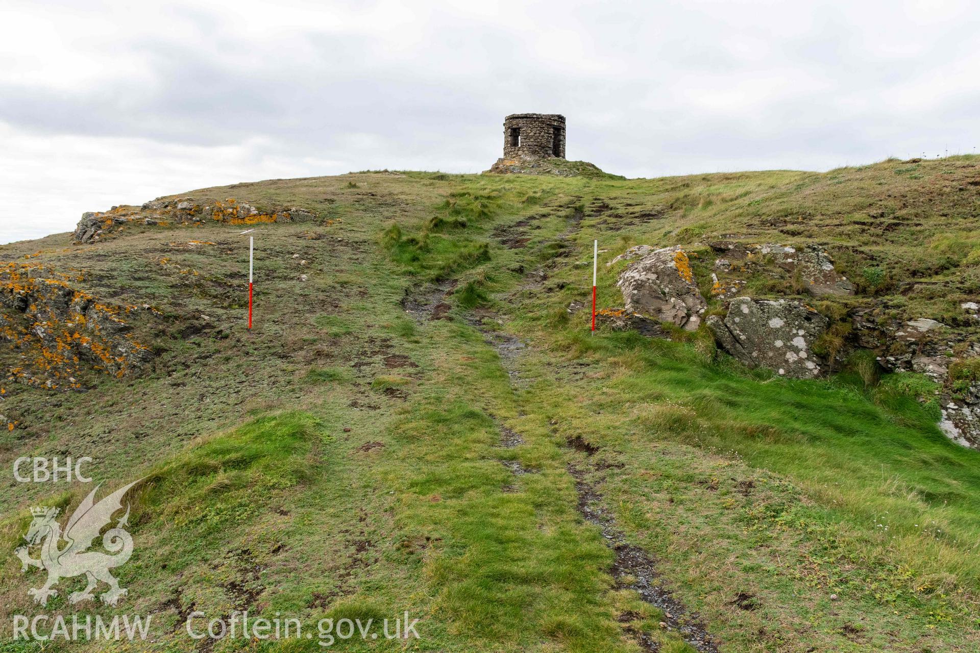 Trwyn Castell coastal promontory fort. Looking west through entrance into the fort interior, created through quarrying and modification of outcropping rock.