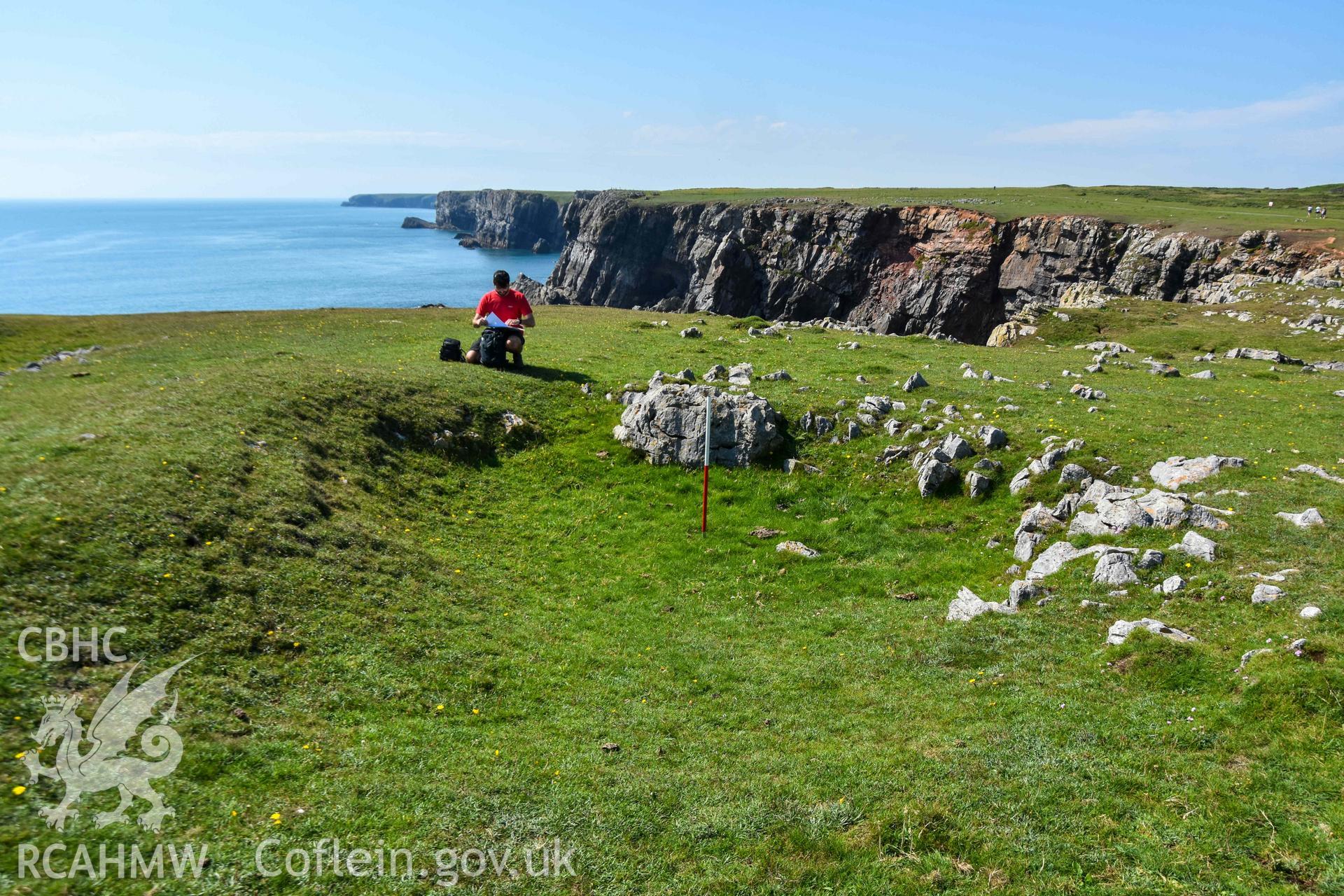 Looking northwest to the end (terminal) of the outer rock-cut ditch (with scale).