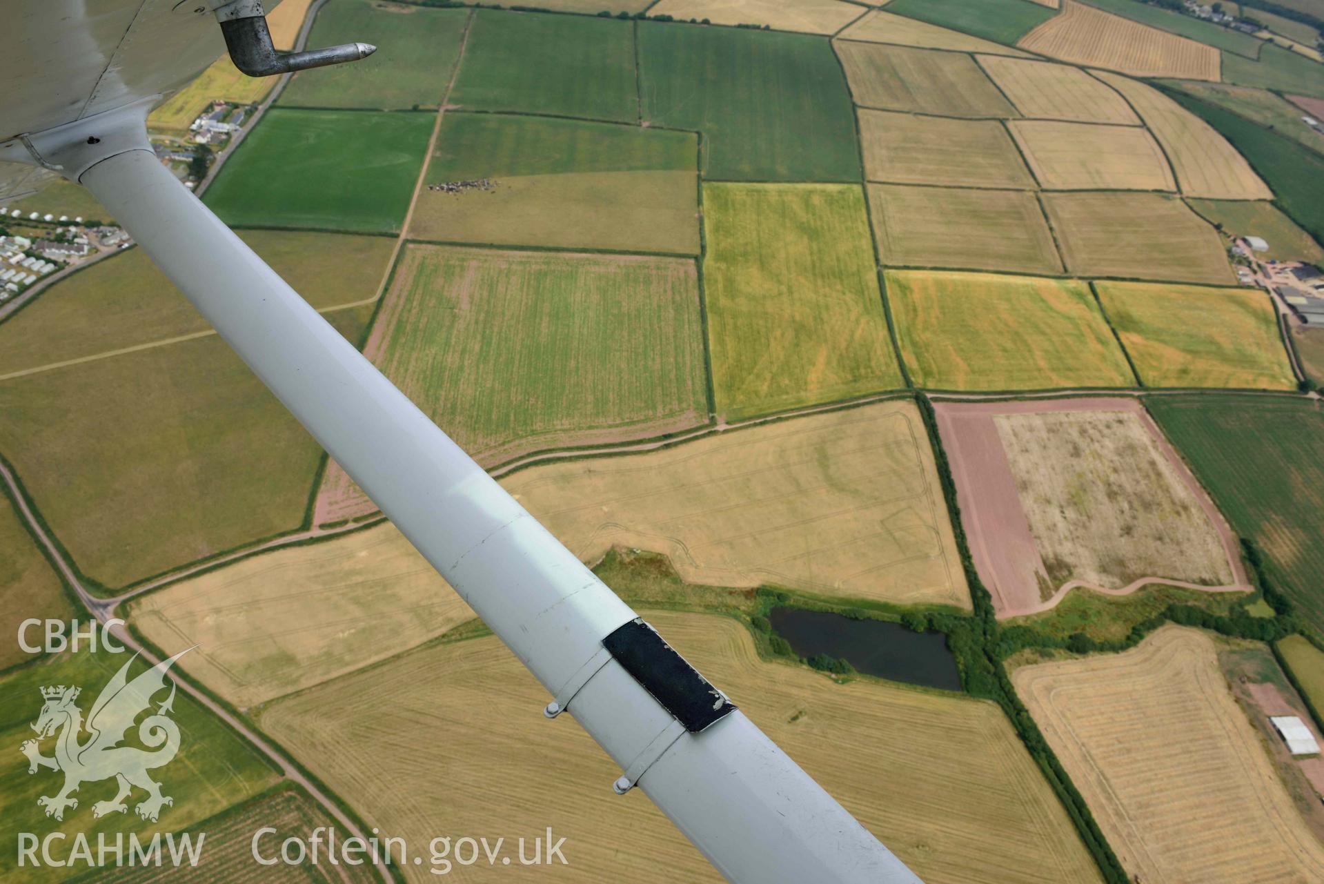 RCAHMW colour oblique aerial photograph of Long lane cropmark enclosure, Hasguard Hall taken on 11 July 2018 by Toby Driver