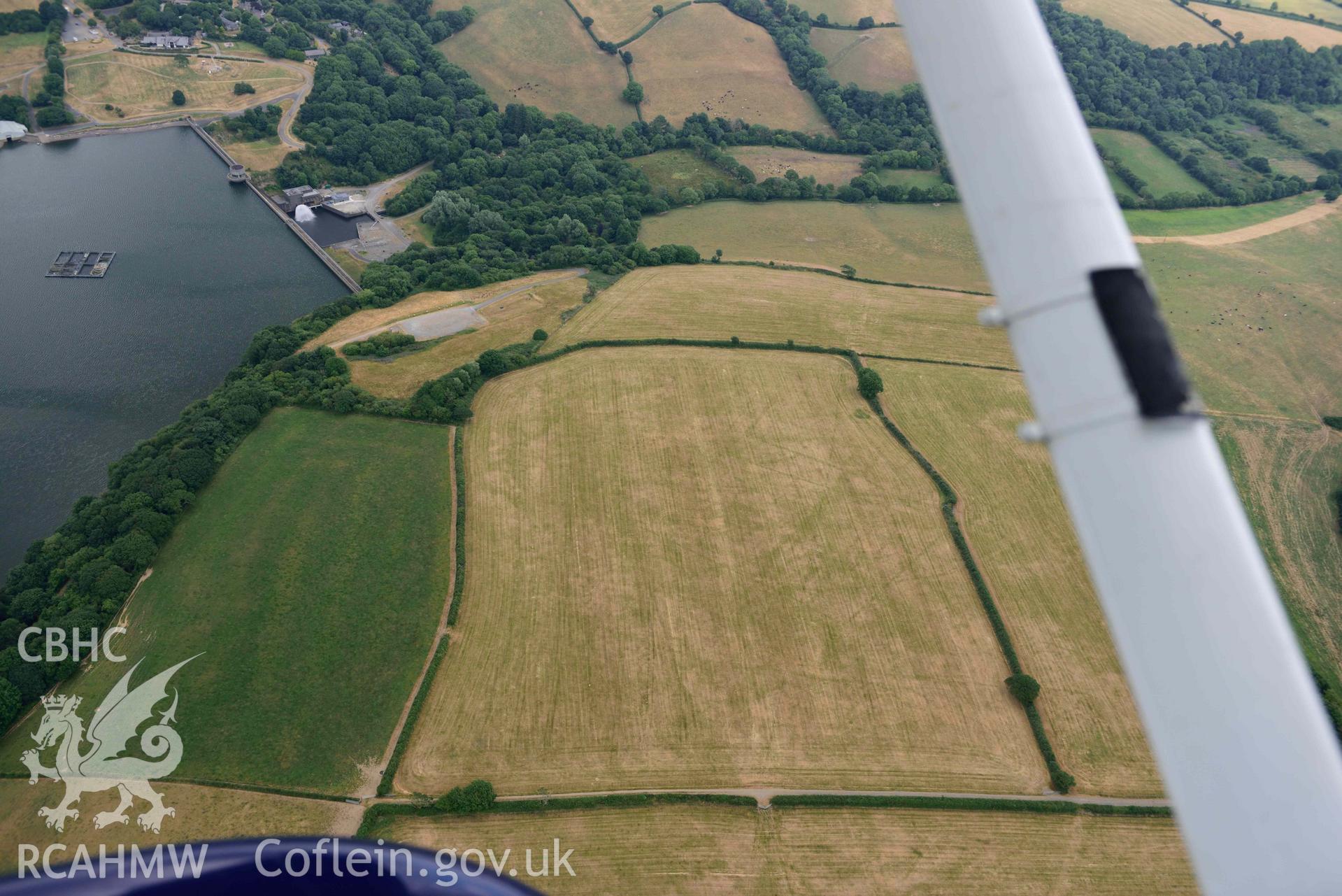 RCAHMW colour oblique aerial photograph of Llys y Fran Walton wood enclosures taken on 11 July 2018 by Toby Driver
