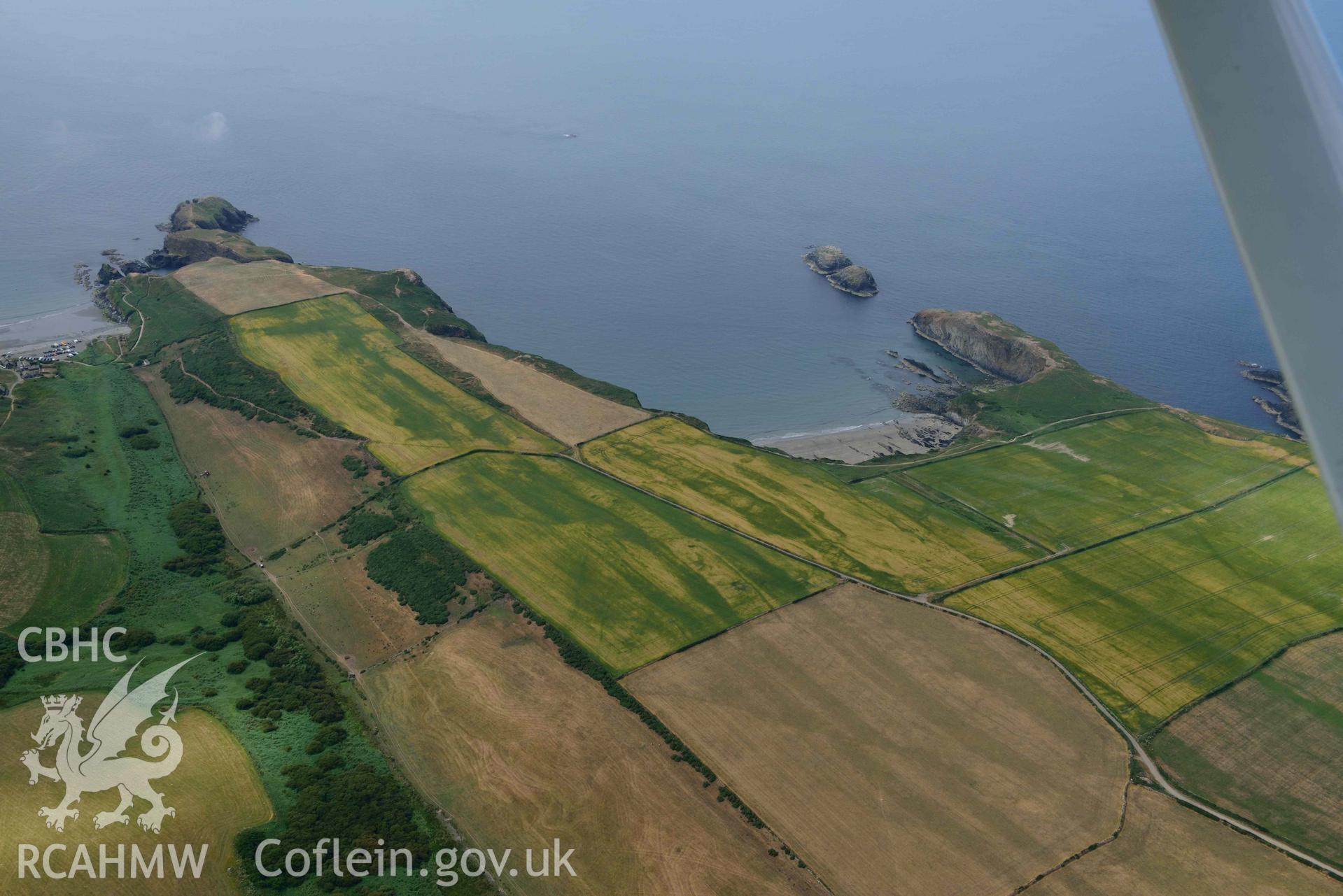 RCAHMW colour oblique aerial photograph ofPorth Egr prom fort and 401457 Abereiddy village cropmarks taken on 11 July 2018 by Toby Driver