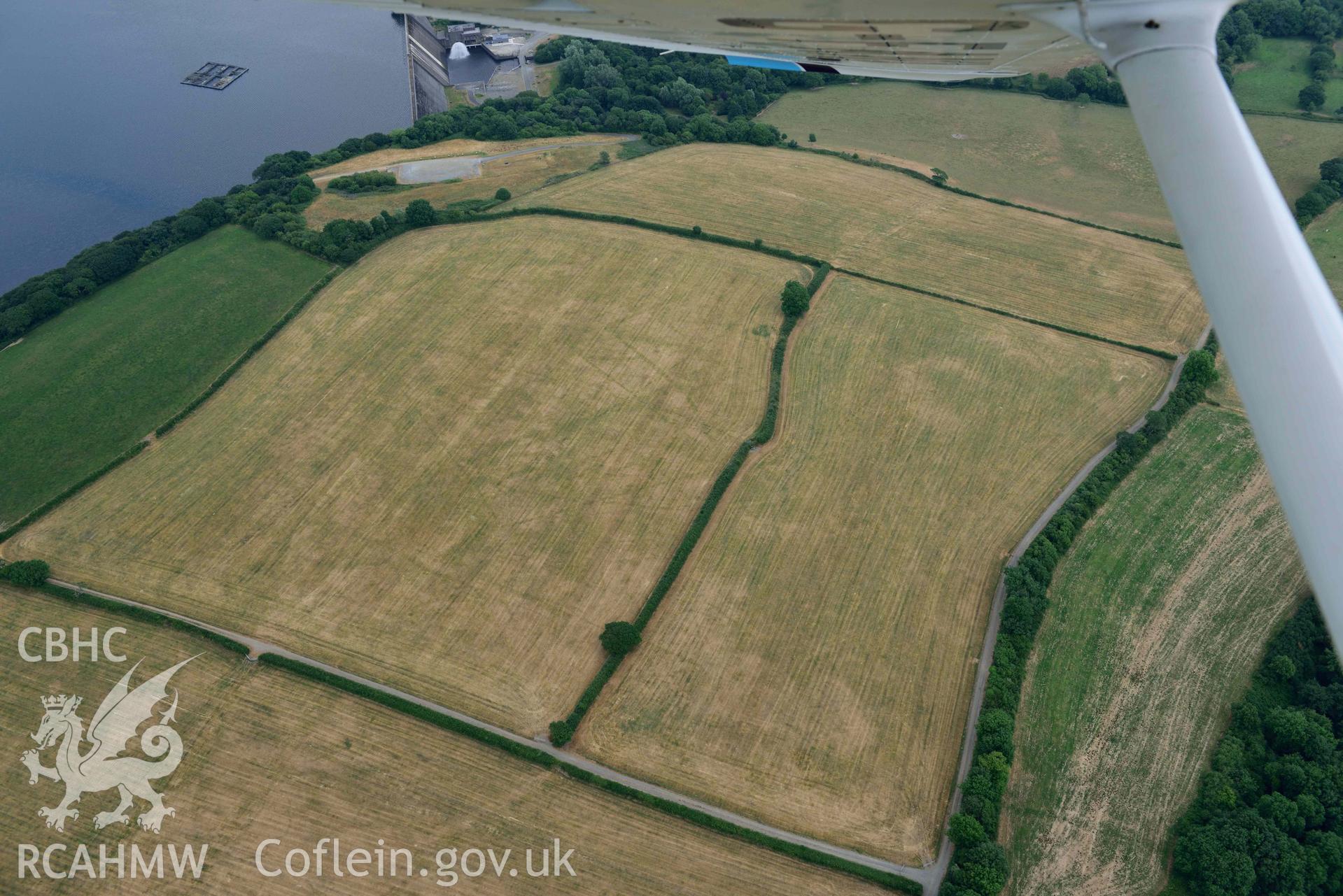 RCAHMW colour oblique aerial photograph of Llys y Fran Walton wood enclosures taken on 11 July 2018 by Toby Driver