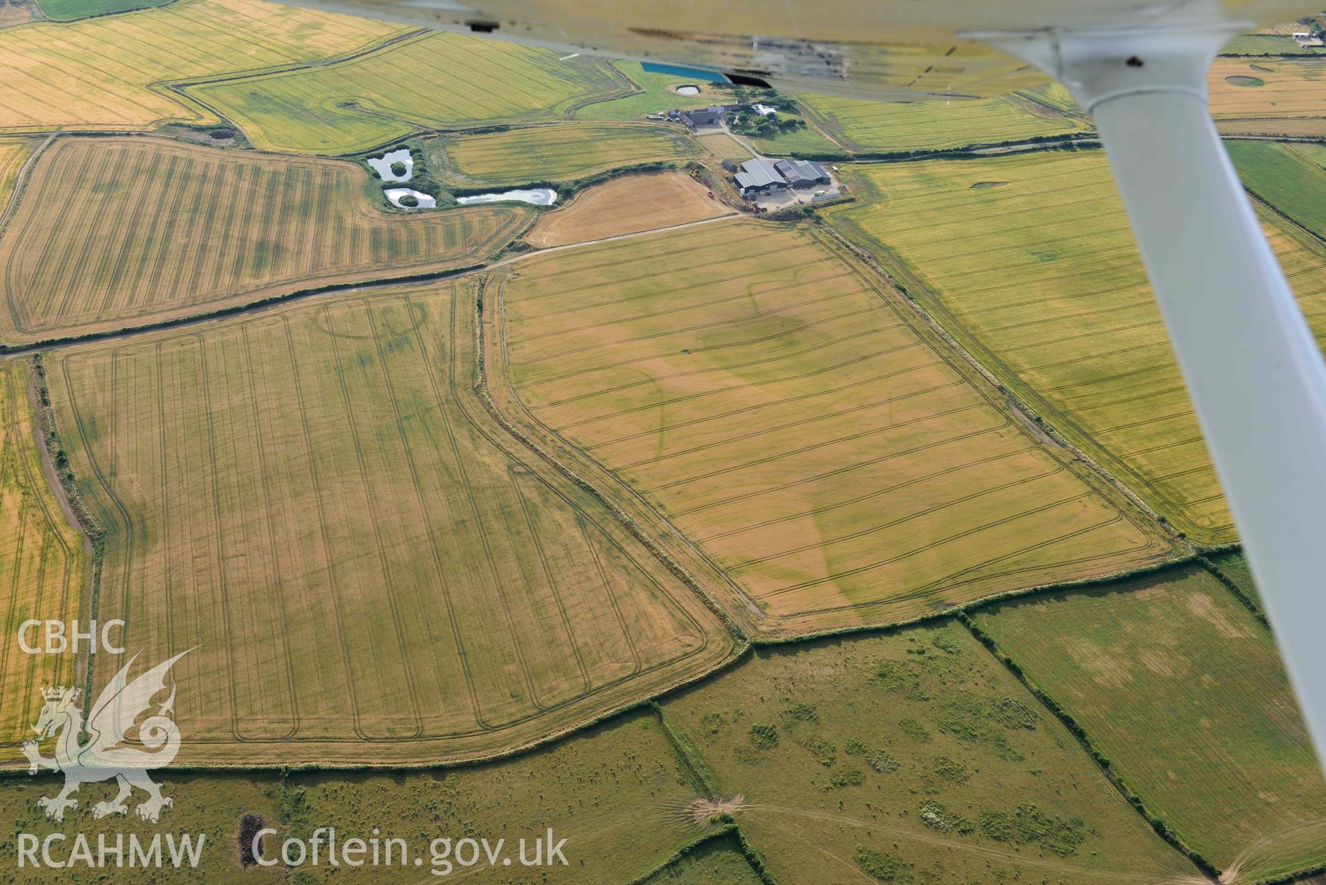 RCAHMW colour oblique aerial photograph of Paviland Manor, cropmark complex; SW circular enclosure & polygonal enclosure, from E taken on 17 July 2018 by Toby Driver (NGR: SS448861)