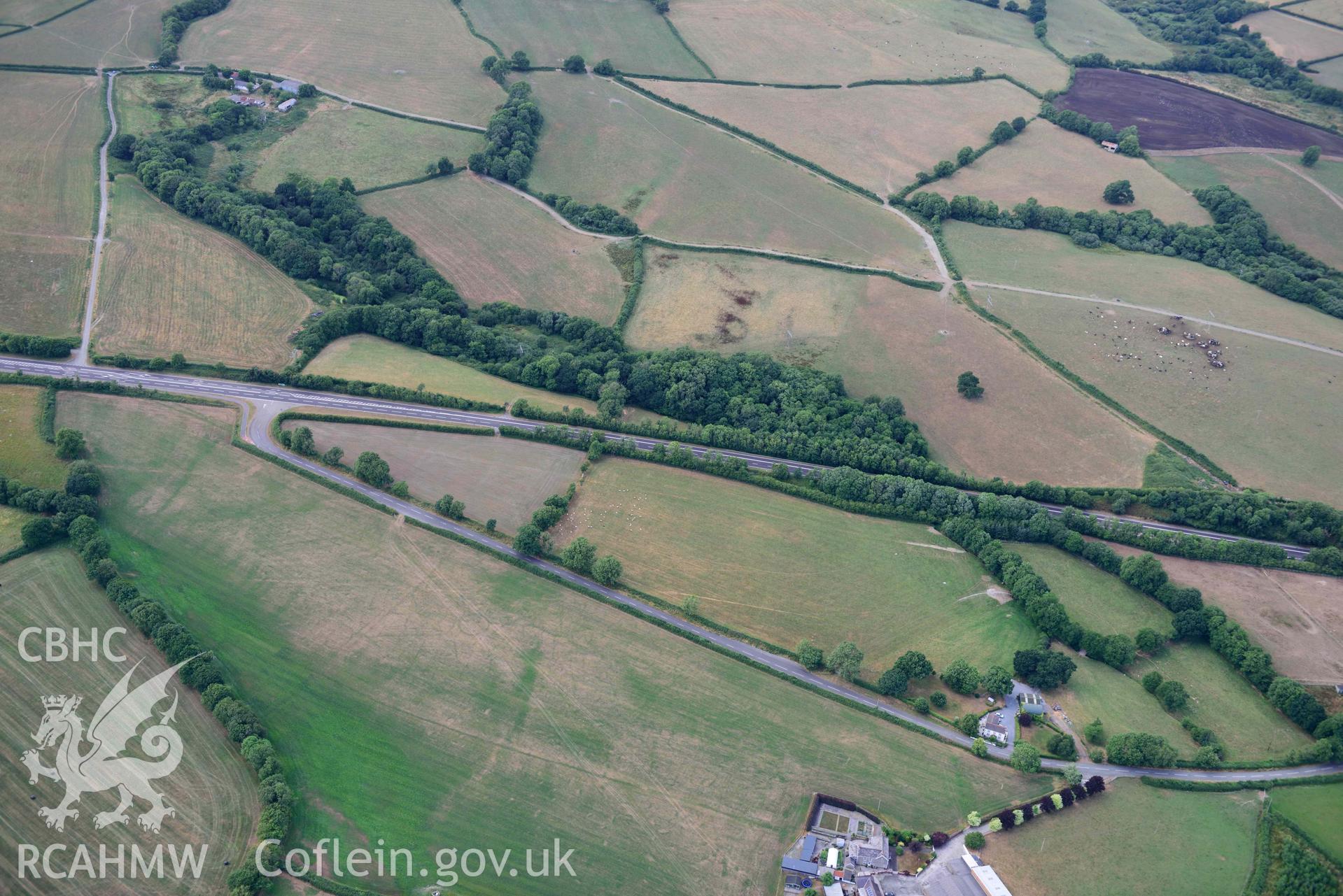 RCAHMW colour oblique aerial photograph of Round barrow cropmark at Moor taken on 17 July 2018 by Toby Driver (NGR: SN230169)