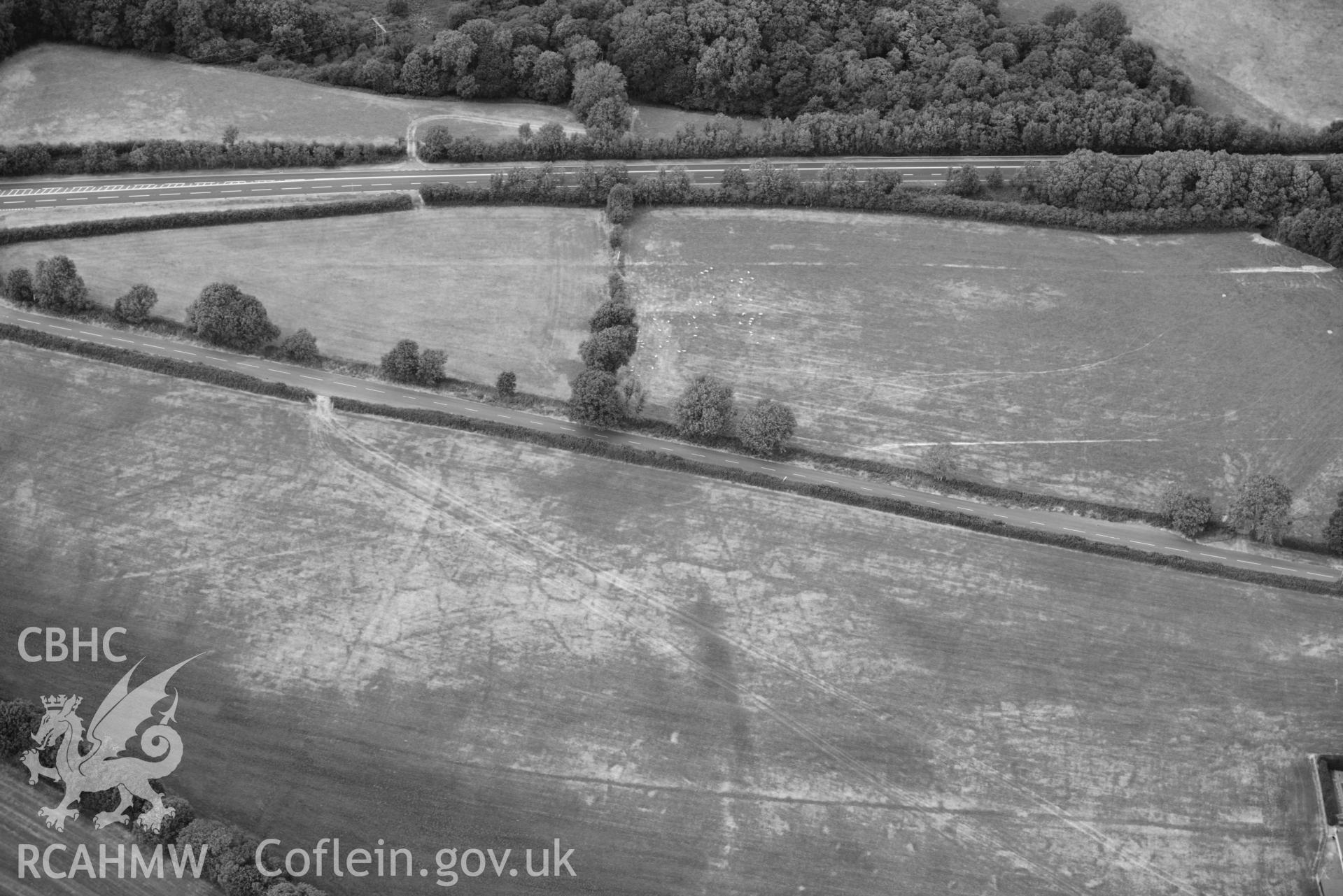 RCAHMW colour oblique aerial photograph of Round barrow cropmark at Moor taken on 17 July 2018 by Toby Driver (NGR: SN230169)