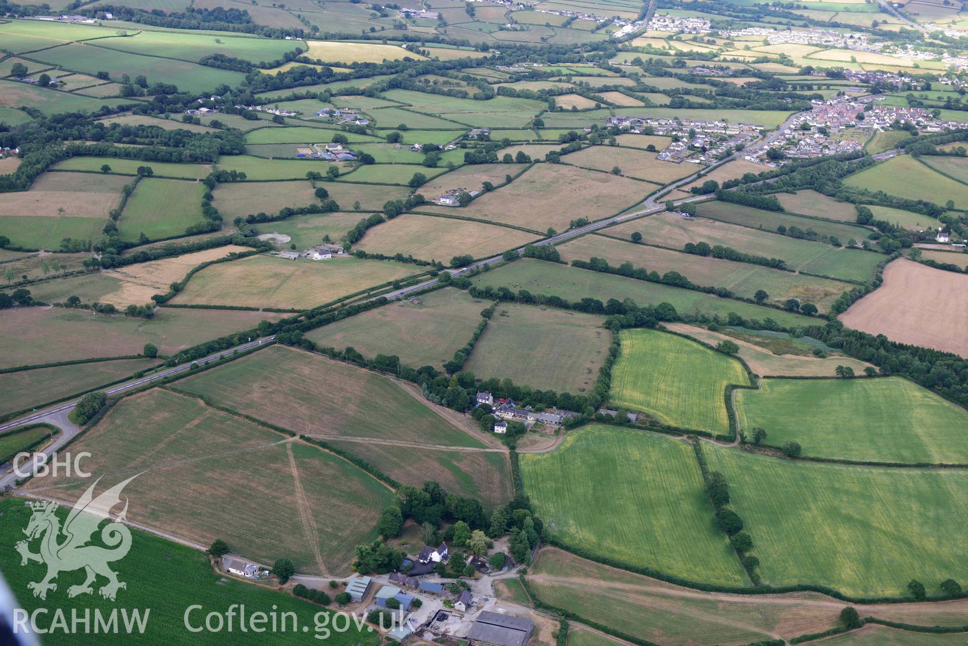 RCAHMW colour oblique aerial photograph of Roman road cropmark west of Pwll-trap, taken on 17 July 2018 by Toby Driver (NGR: SN256168)