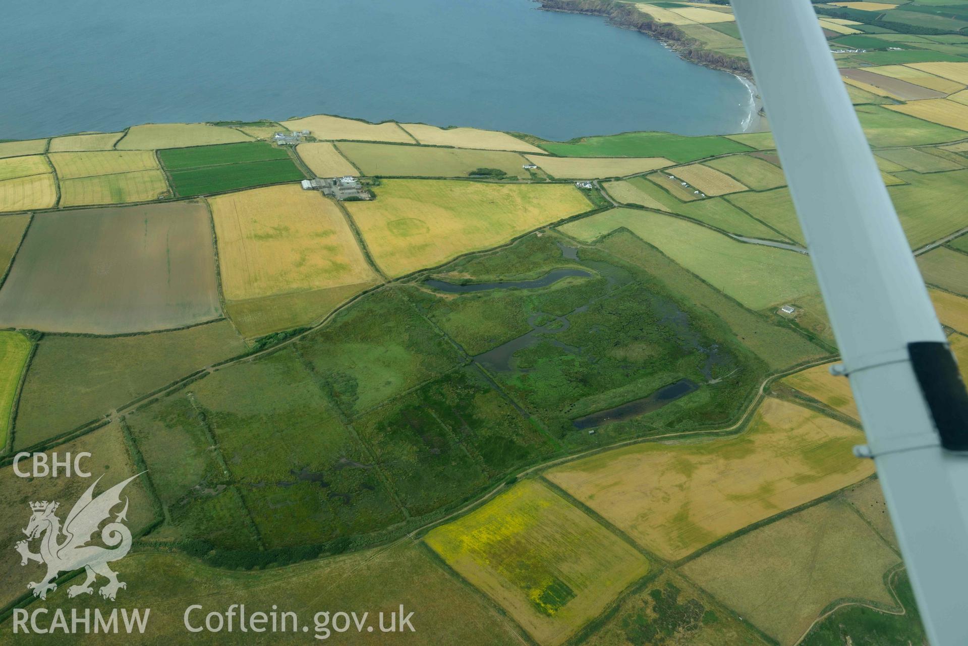 RCAHMW colour oblique aerial photograph of Runwayskiln Prehistoric Settlement Cropmarks, view from S towards Trehill Farm taken on 17 July 2018 by Toby Driver (NGR: SM776079)