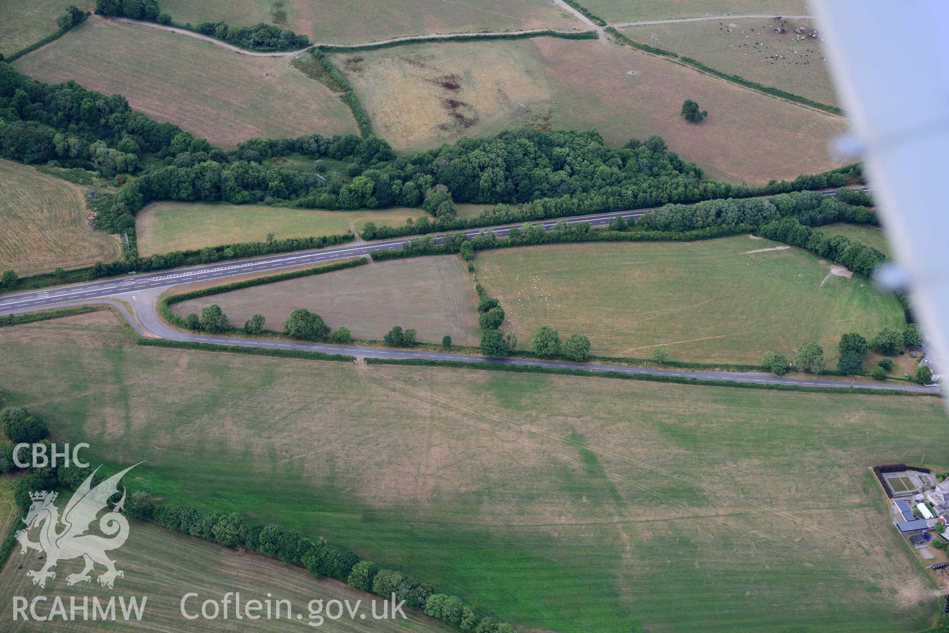 RCAHMW colour oblique aerial photograph of Round barrow cropmark at Moor taken on 17 July 2018 by Toby Driver (NGR: SN230169)