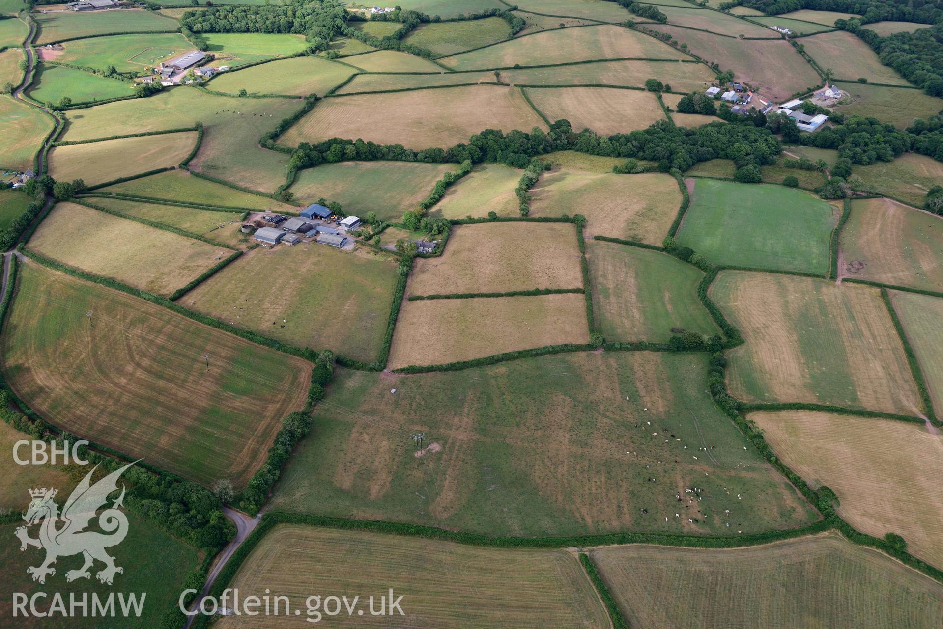 RCAHMW colour oblique aerial photograph of Roman road from Carmarthen to Kidwelly; Road parchmarks at Bwlch y gwynt, view from W taken on 17 July 2018 by Toby Driver (NGR: SN411150)