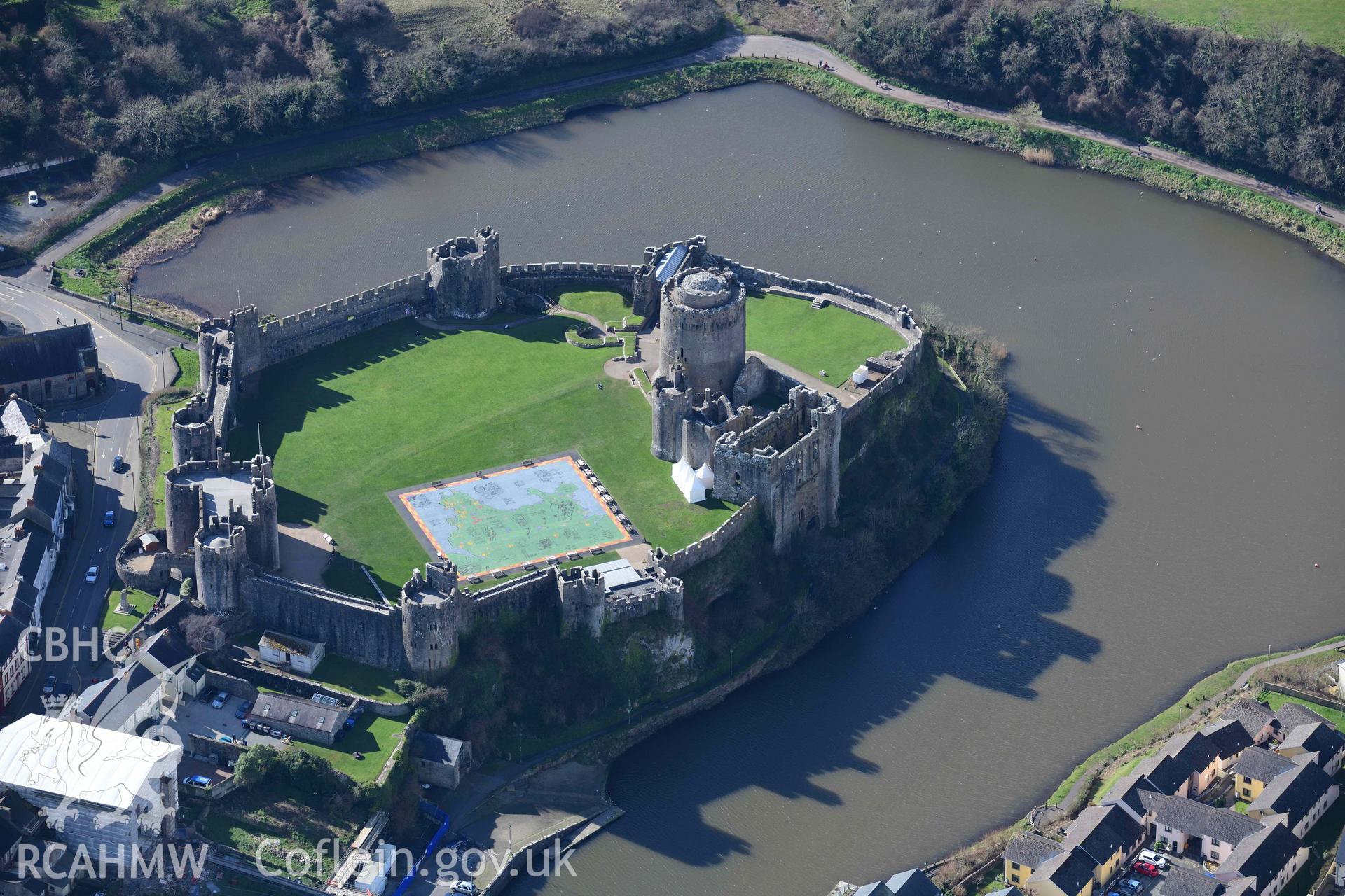 RCAHMW colour oblique aerial photograph of Pembroke Castle, casting shadows to north taken on 4 March 2022 by Toby Driver ((SM981016)