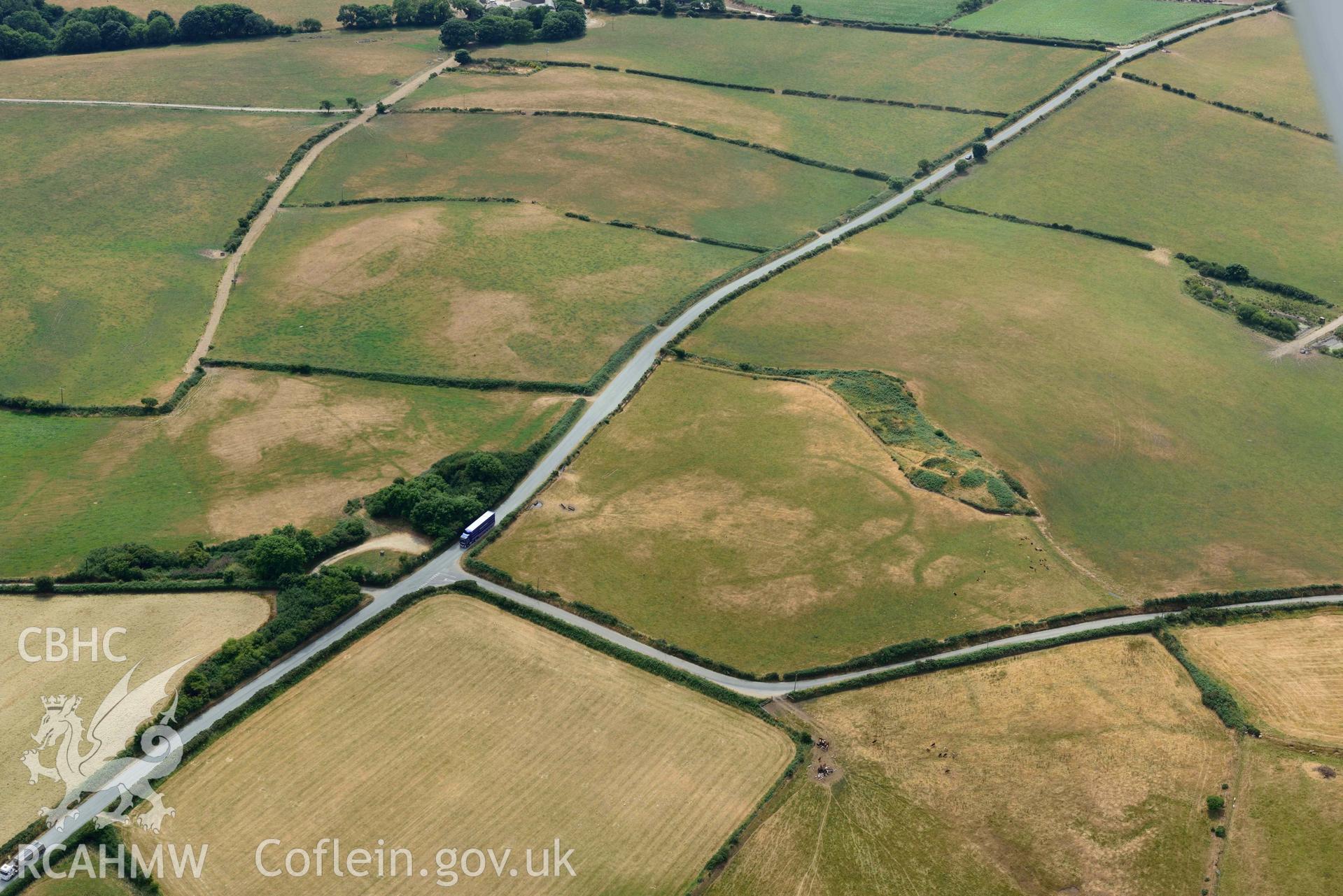 RCAHMW colour oblique aerial photograph of Crugiau Cemmaes Barrow Cemetary + Crugiau Cemmaes Banjo enclosure taken on 11 July 2018 by Toby Driver