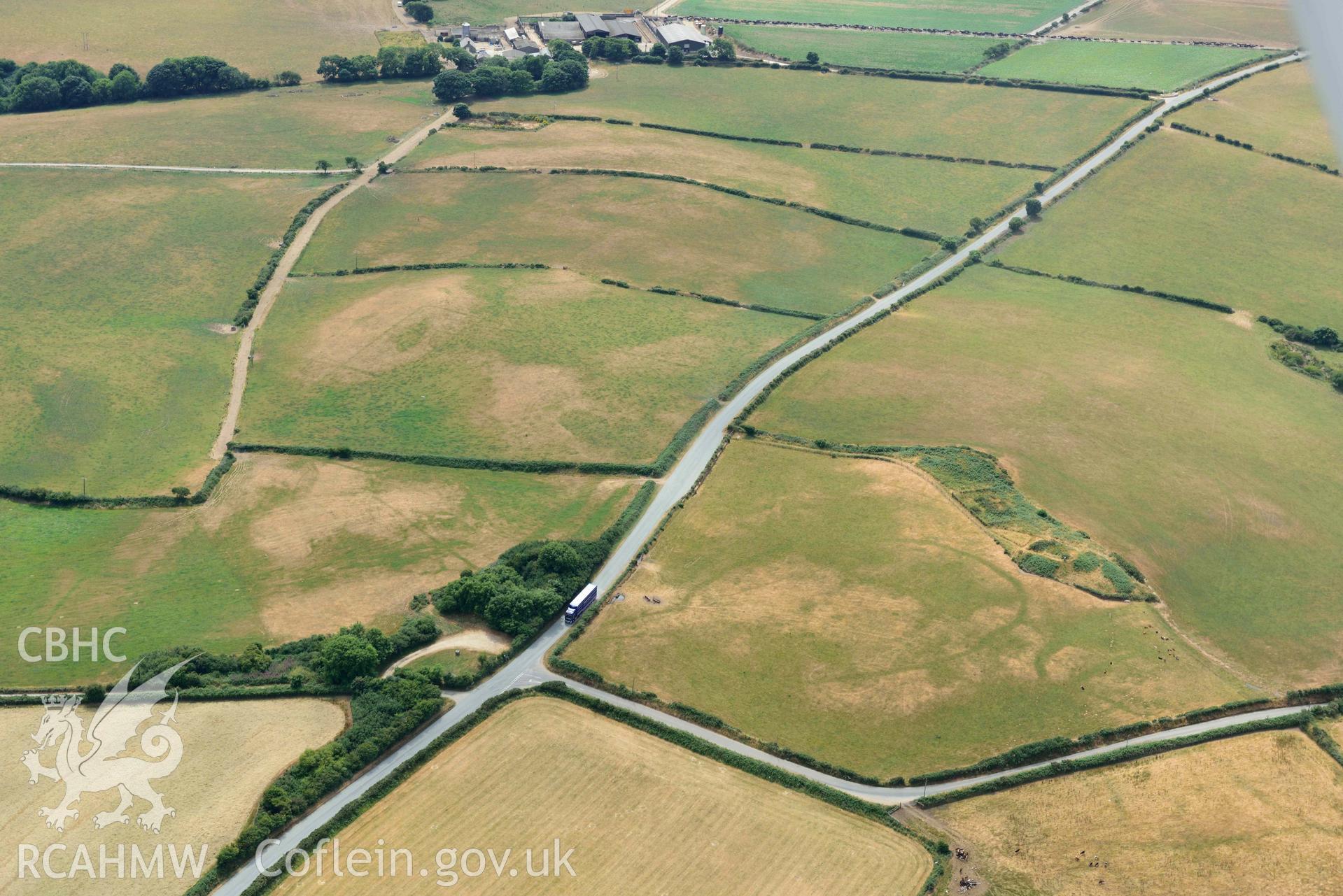 RCAHMW colour oblique aerial photograph of Crugiau Cemmaes Barrow Cemetary + Crugiau Cemmaes Banjo enclosure taken on 11 July 2018 by Toby Driver