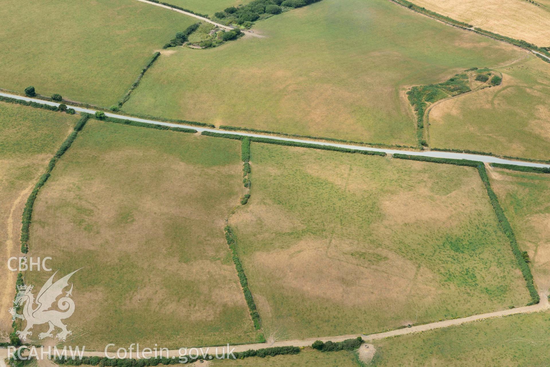 RCAHMW colour oblique aerial photograph of Crugiau Cemmaes Barrow Cemetary, Crugiau Cemmaes Southeast (Rectangular Enclosure) taken on 11 July 2018 by Toby Driver