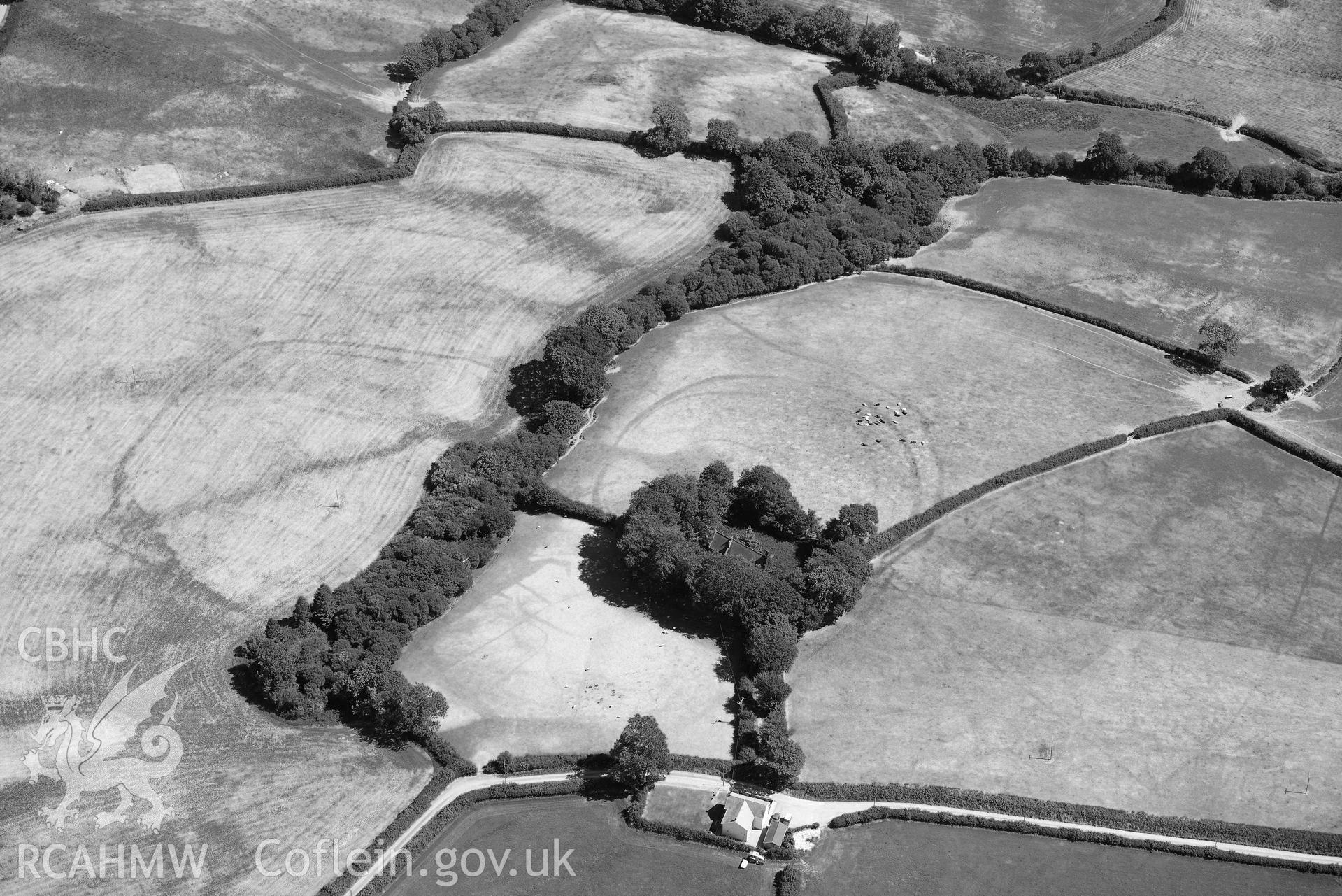 RCAHMW black and white oblique aerial photograph of  St Cannas enclosure complex taken on 9 July 2018 by Toby Driver