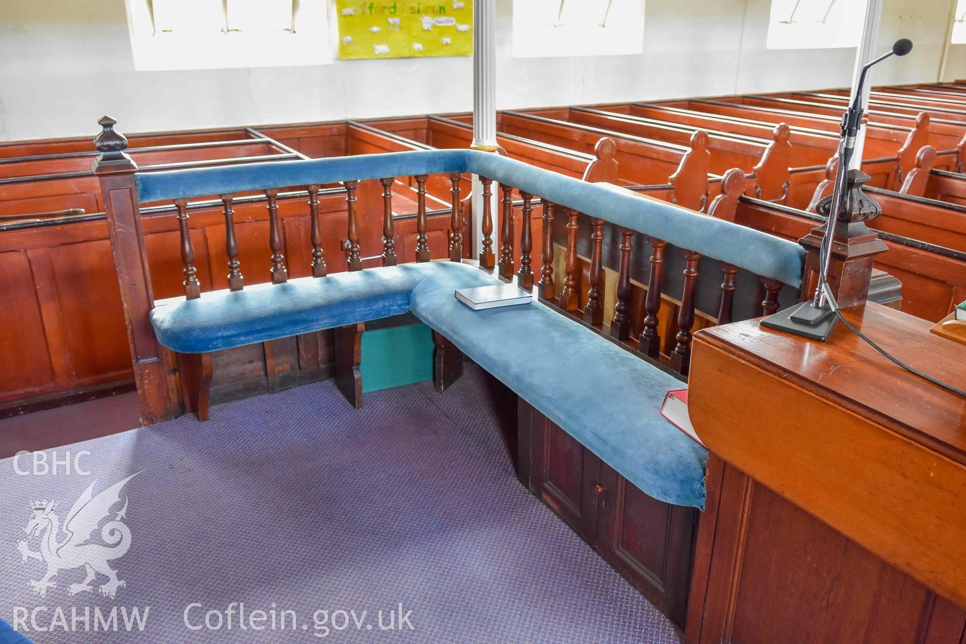 Tabernacl Welsh Independent Chapel - View of cushioned pews surrounding the communion table, taken from North-West