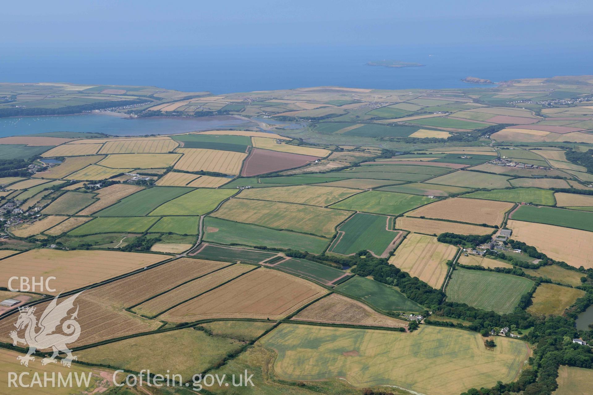 Aerial photography of Dale village, summer landscape from St Ishmaels Aerial reconnaissance survey for the CHERISH Project. Crown Copyright: CHERISH PROJECT 2018. Produced with EU funds through the Ireland Wales Co-operation Programme 2014-2020. All material made freely available through the Open Government Licence.