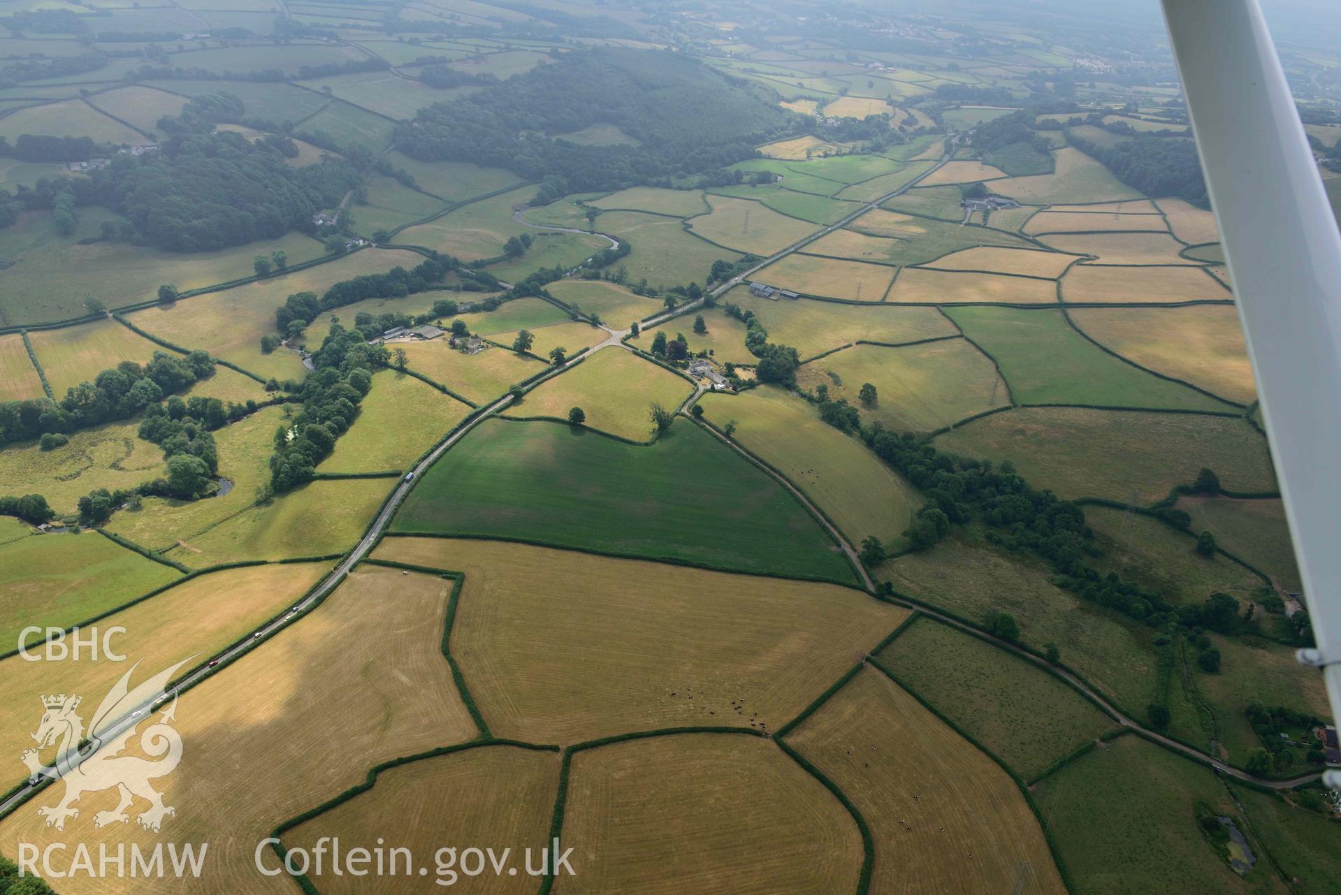 Aerial photography of Landscape south of Pontmorlais, and Roman Road 60 Carmarthan to Kidwelly at Pontmorlais Cottage Aerial reconnaissance survey for the CHERISH Project. Crown Copyright: CHERISH PROJECT 2018. Produced with EU funds through the Ireland Wales Co-operation Programme 2014-2020. All material made freely available through the Open Government Licence.