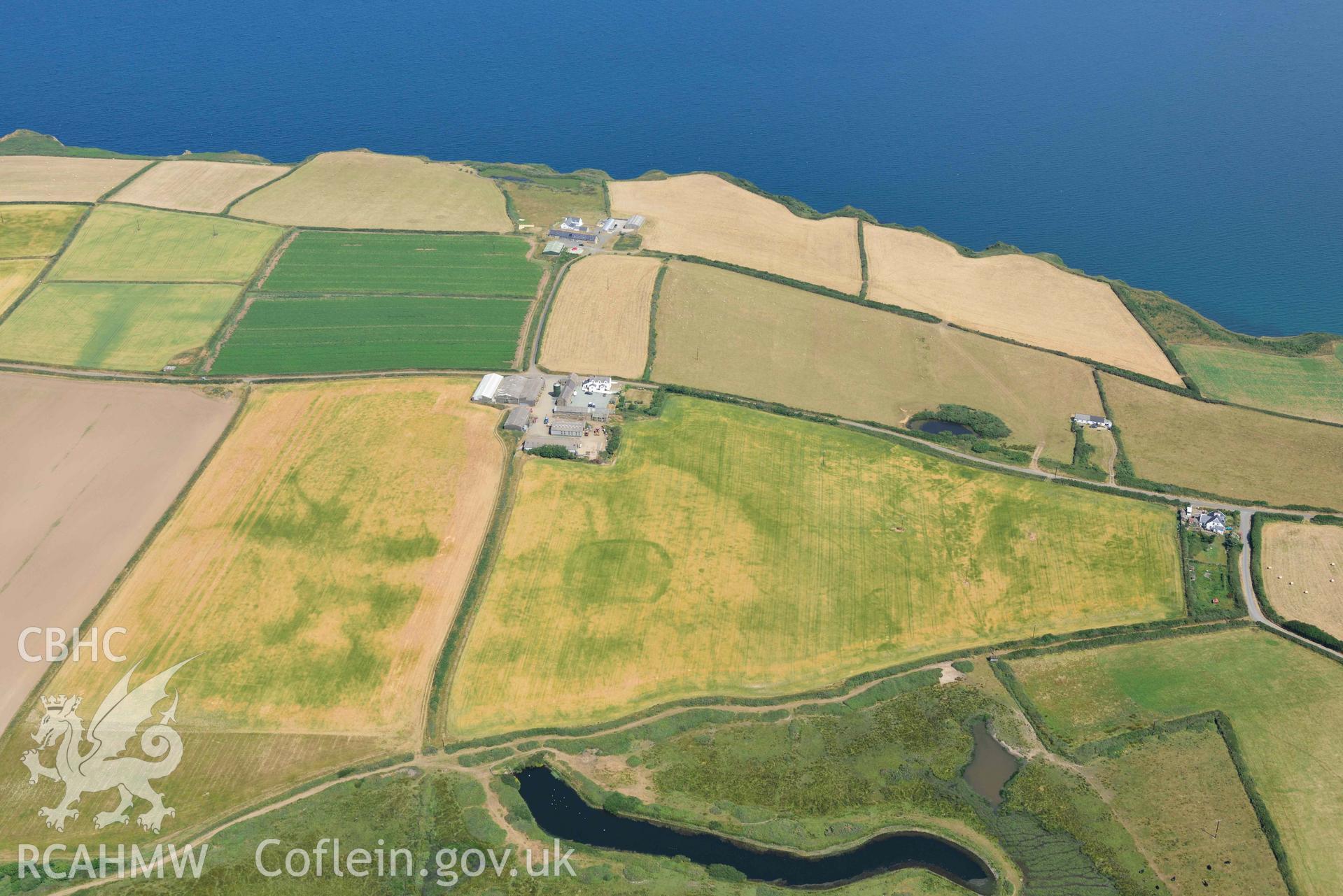 Aerial photography of Trehill Farm defended enclosure, Marloes Aerial reconnaissance survey for the CHERISH Project. Crown Copyright: CHERISH PROJECT 2018. Produced with EU funds through the Ireland Wales Co-operation Programme 2014-2020. All material made freely available through the Open Government Licence.