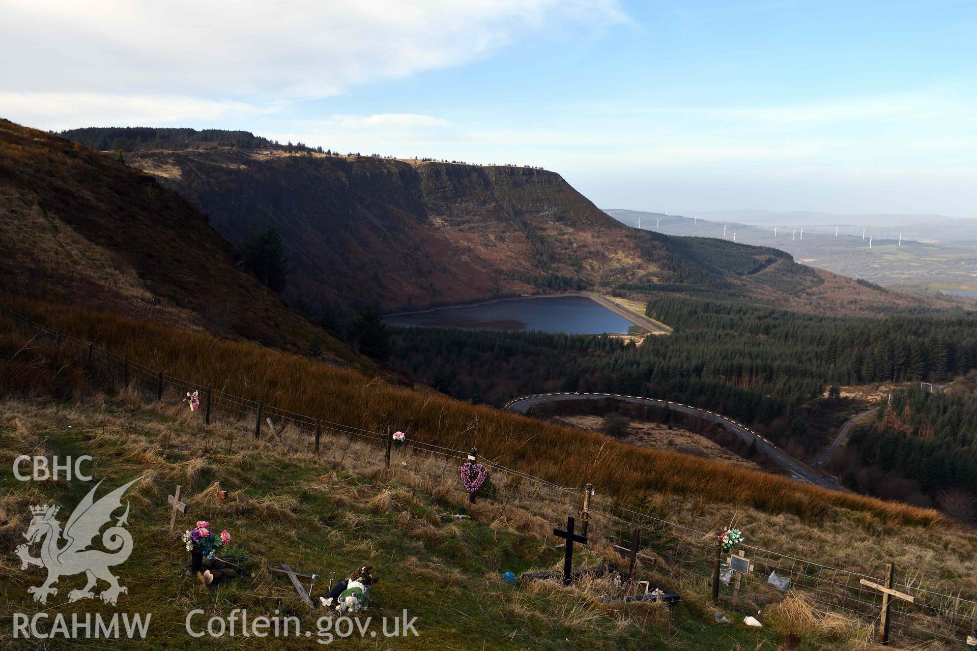Landscape view of lake looking west from Rhigos Viewpoint, with modern memorials on hillslope