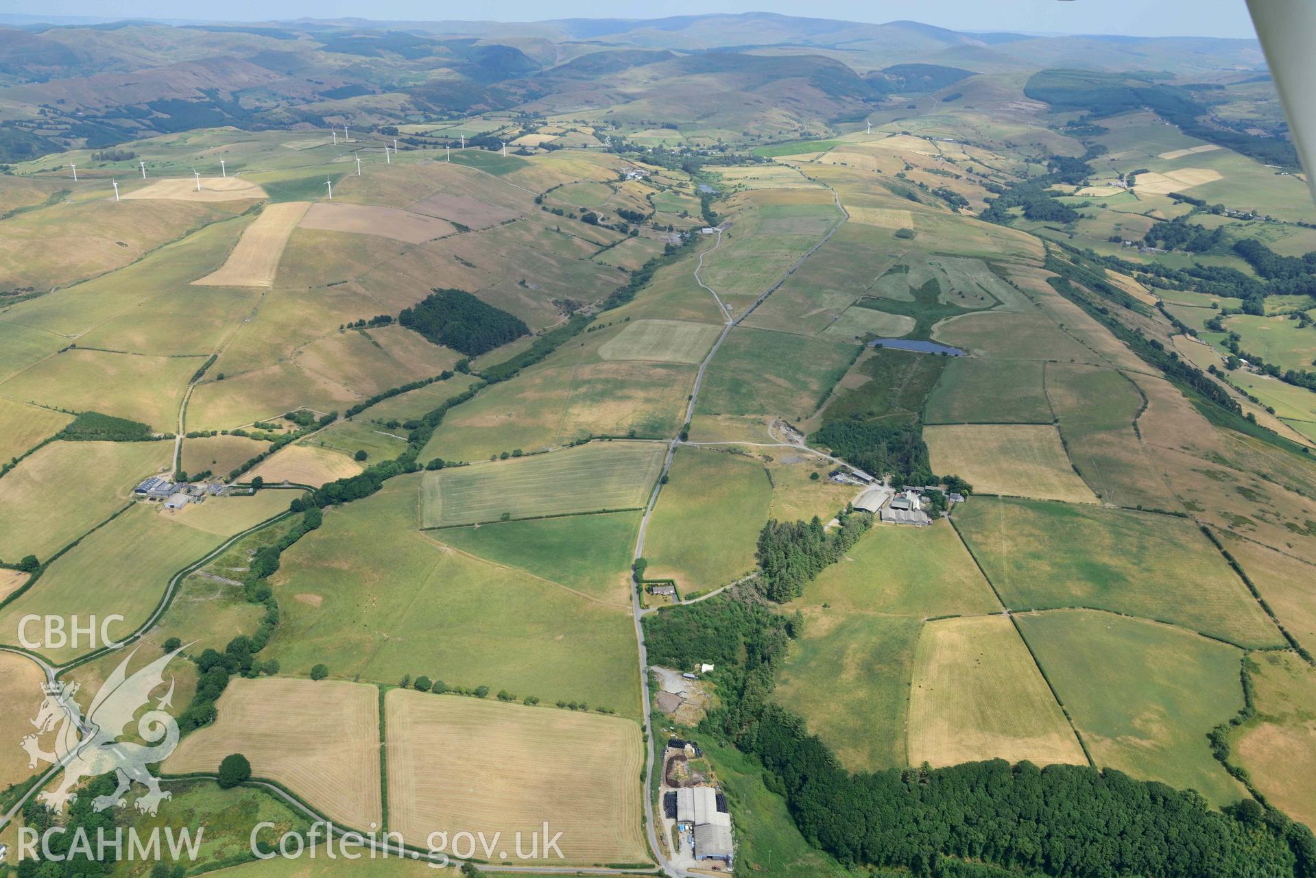 Aerial photograph: Court Grange Lead Mine; landscape from west with parchmarks. Crown: CHERISH PROJECT 2018. Produced with EU funds through the Ireland Wales Co-operation Programme 2014-2020 (NGR SN655855)