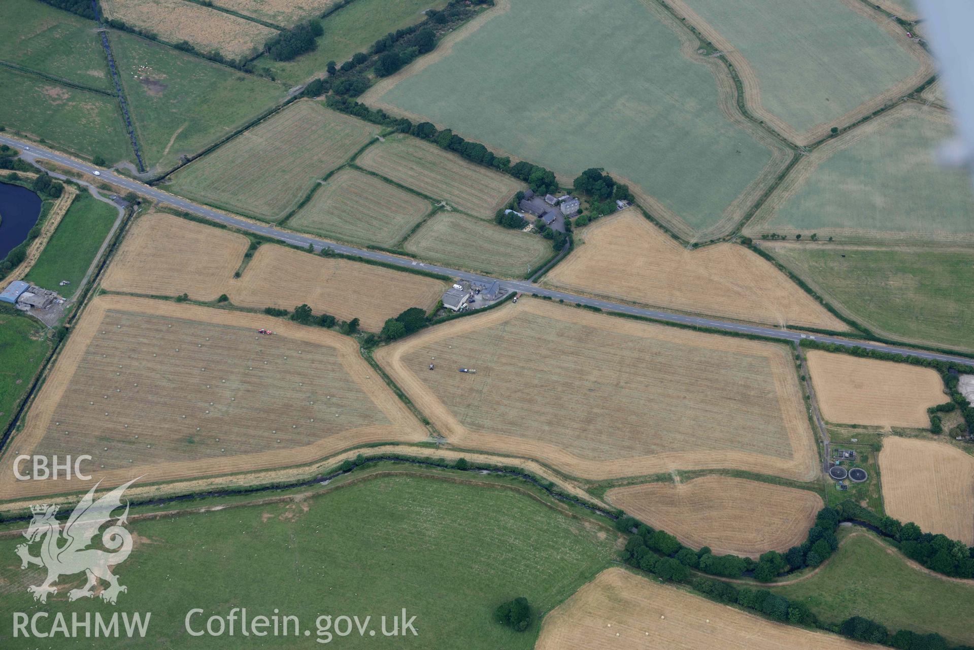 Aerial photograph: Bryn-crug cropmark complex; main ring showing faintly in ripened crop during harvesting of field perimeter. Crown: CHERISH PROJECT 2018. Produced with EU funds through the Ireland Wales Co-operation Programme 2014-2020 (NGR SH603034)