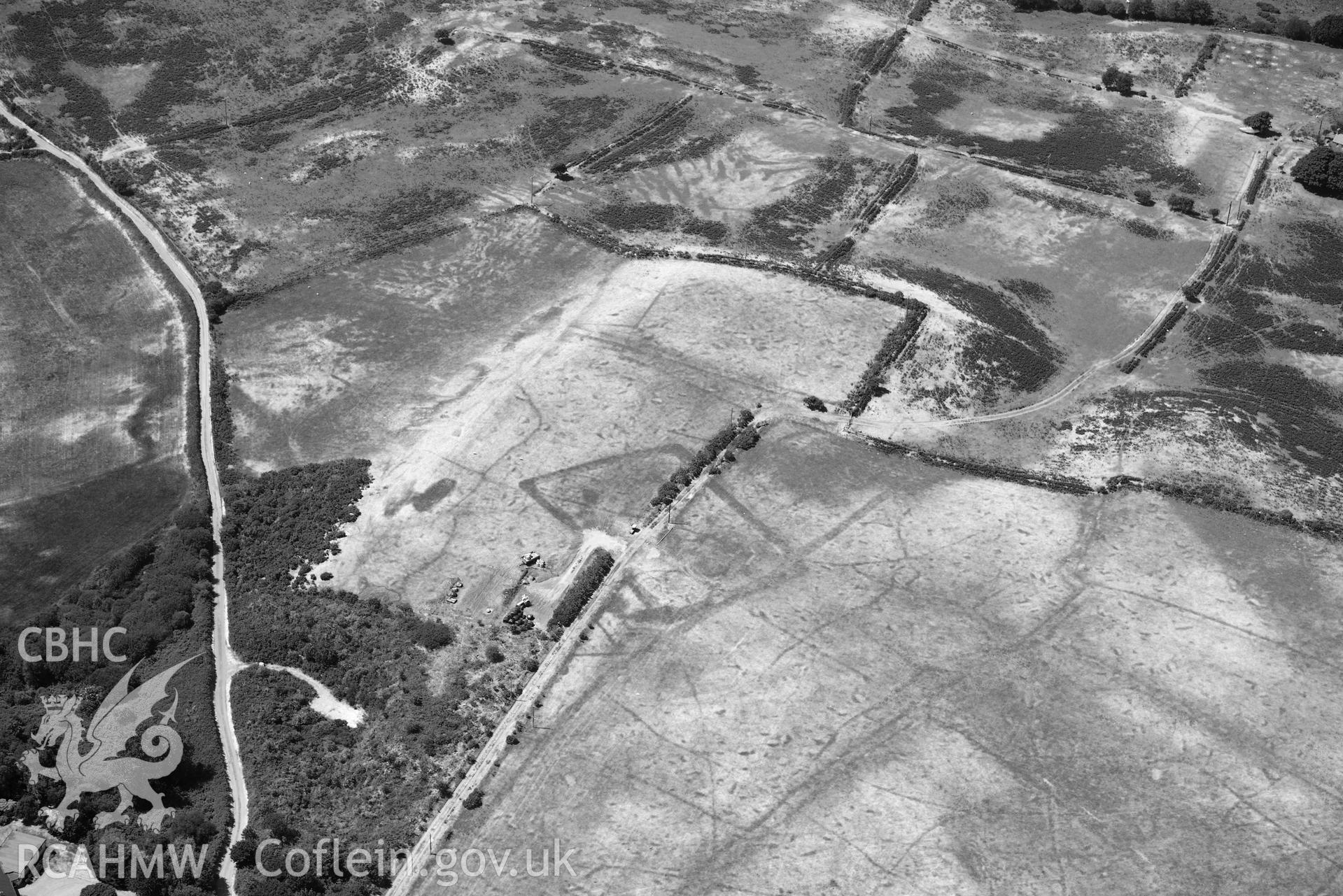 Aerial photograph: Traian, rectangular defended enclosure and field systems. Crown: CHERISH PROJECT 2018. Produced with EU funds through the Ireland Wales Co-operation Programme 2014-2020 (NGR SH329363)