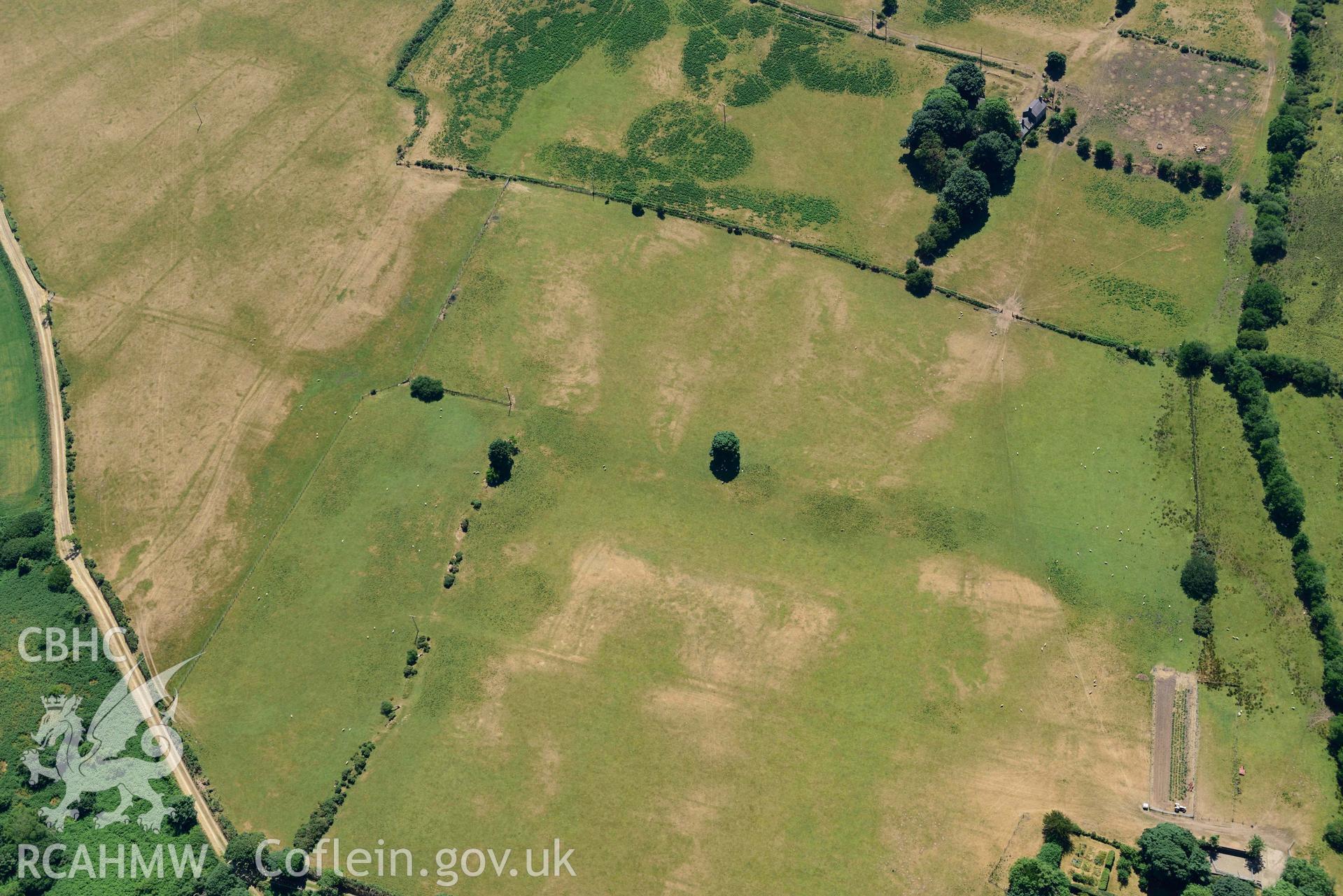 Aerial photograph: Traian, rectangular defended enclosure, distant view from northwest over Cefn-iwrch. Crown: CHERISH PROJECT 2018. Produced with EU funds through the Ireland Wales Co-operation Programme 2014-2020 (NGR SH329363)
