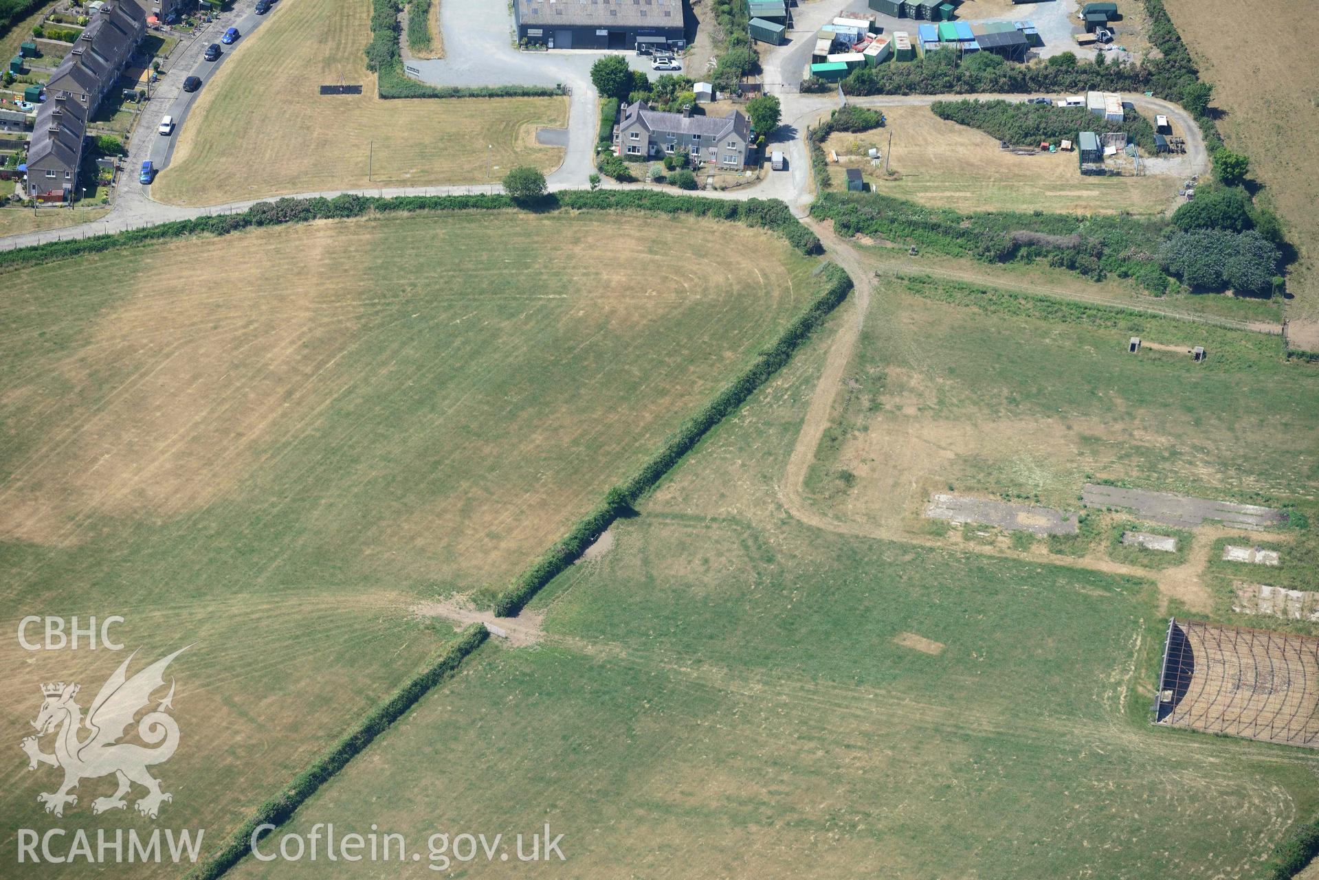 Aerial photograph: Cropmark defended enclosure, north-east of Polish Home, Penrhos airfield. Crown: CHERISH PROJECT 2018. Produced with EU funds through the Ireland Wales Co-operation Programme 2014-2020 (NGR SH339342)