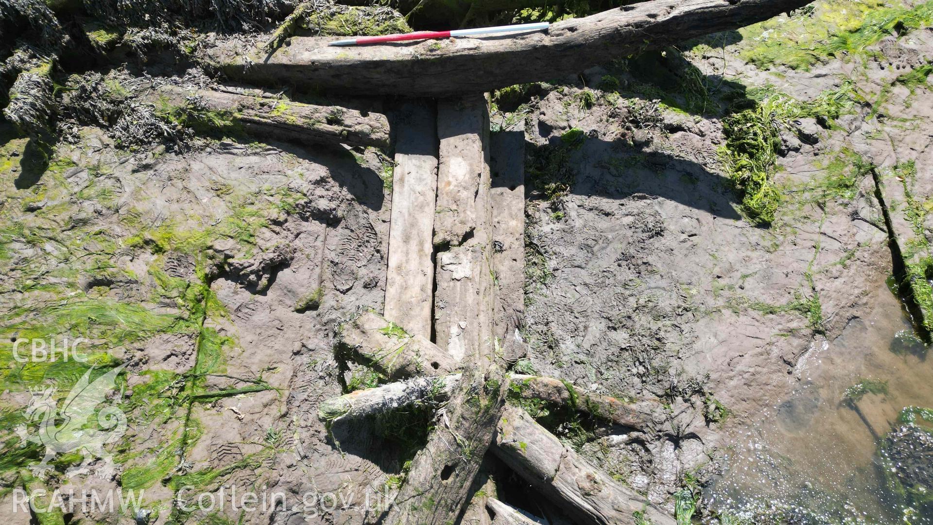 Oblique view of the keel, garboard strakes, and a floor timber, of the Sandy Haven Pill wreck, on 20/06/2023, scale is 1m.