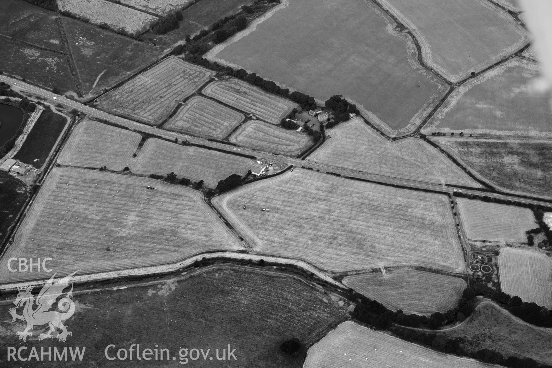 Aerial photograph: Bryn-crug cropmark complex; main ring showing faintly in ripened crop during harvesting of field perimeter. Crown: CHERISH PROJECT 2018. Produced with EU funds through the Ireland Wales Co-operation Programme 2014-2020 (NGR SH603034)
