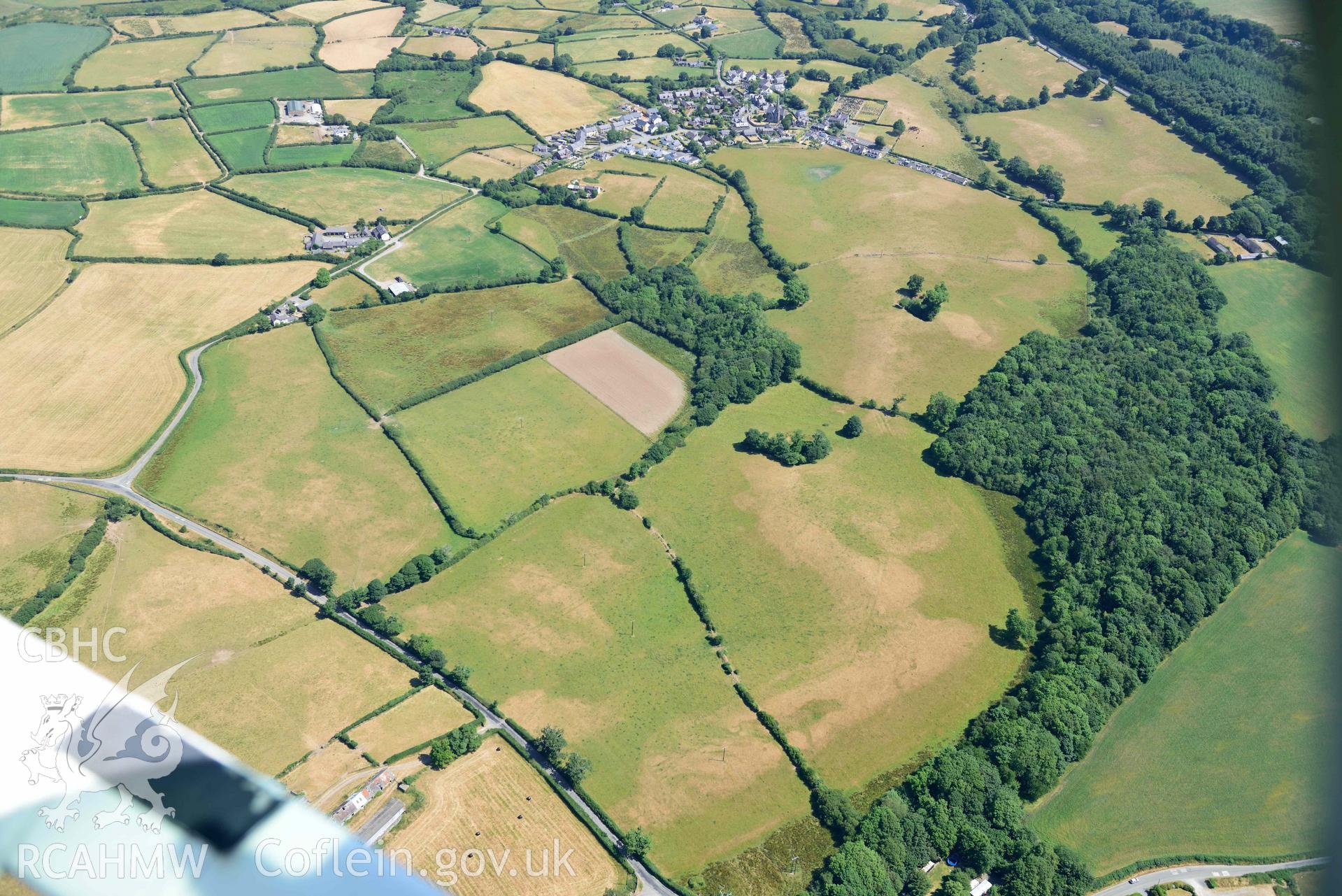 Aerial photograph: Llandwrog village, and non-archaeological parchmarks, view from southwest. Crown: CHERISH PROJECT 2018. Produced with EU funds through the Ireland Wales Co-operation Programme 2014-2020 (NGR: SH451560)