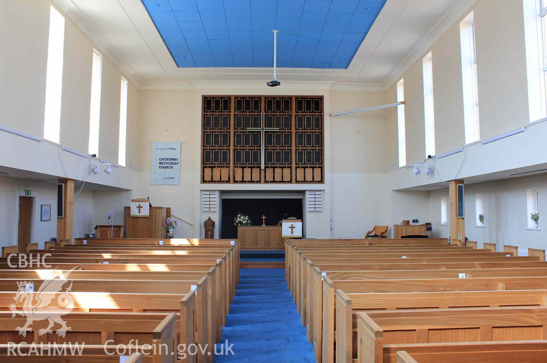 Central aisle towards front altar and pulpit. Pews either side