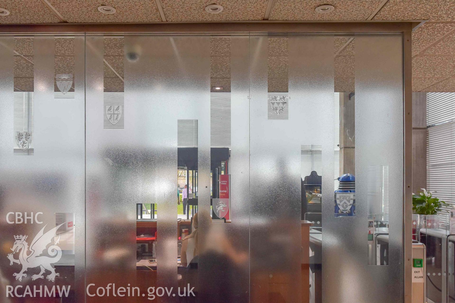 BBC Broadcasting House - Interior, Main Foyer: Detailed view of a frosted window with coats of arms displayed, taken from North