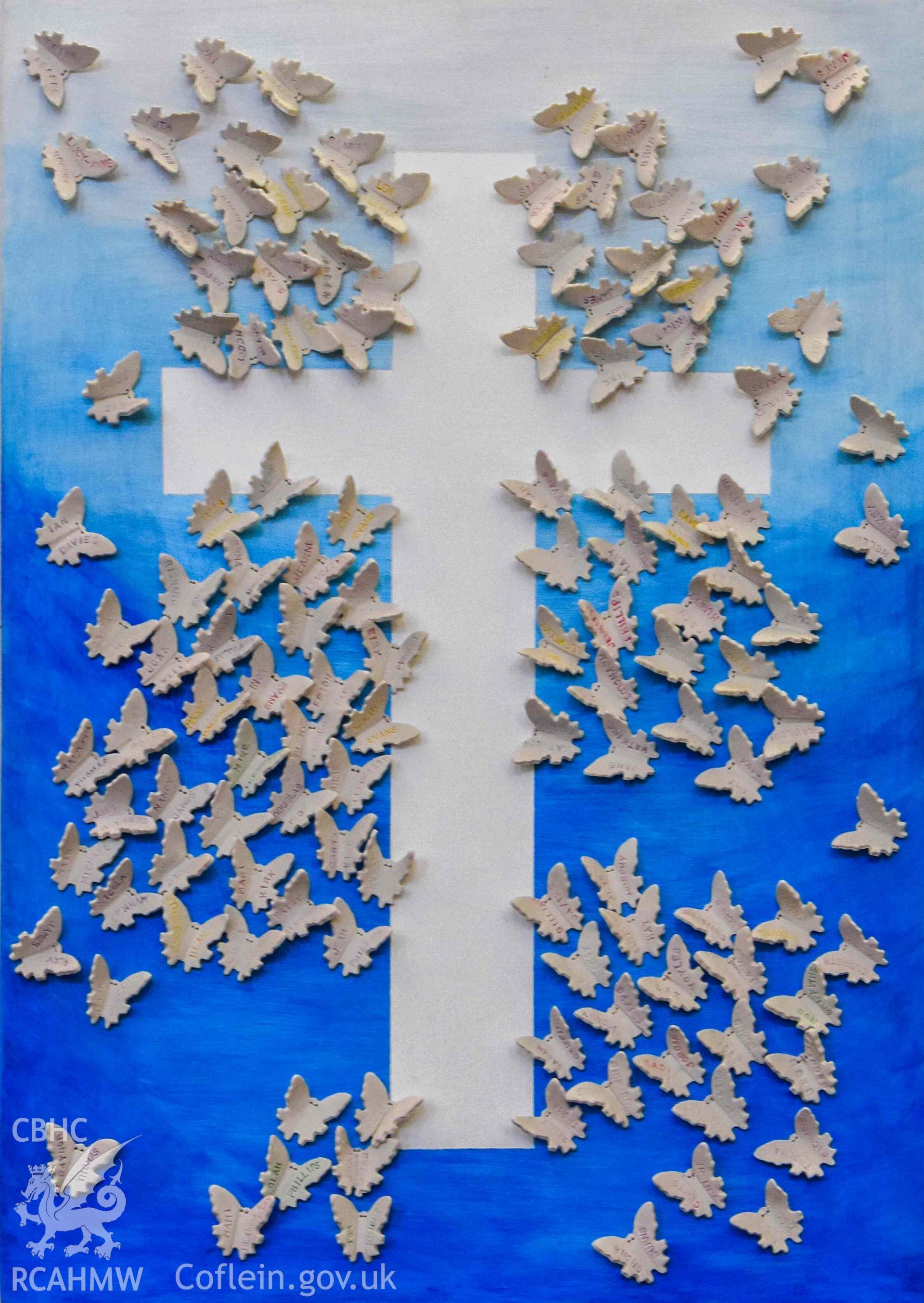 Ebenezer Calvinistic Methodist Chapel - Detailed view of an artwork of a cross with attached butterflies engraved with church members' names