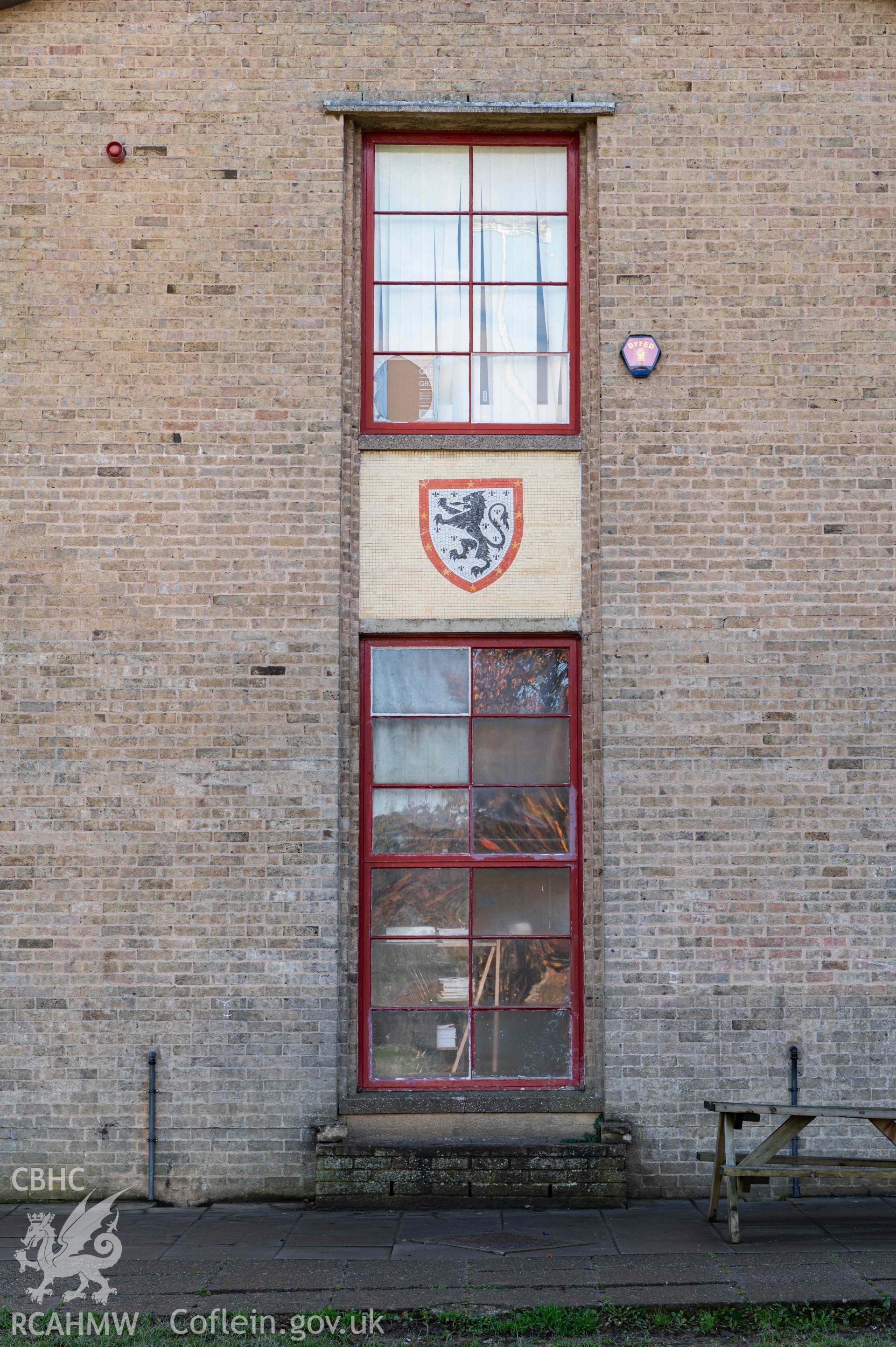 Tall gable window and school emblem