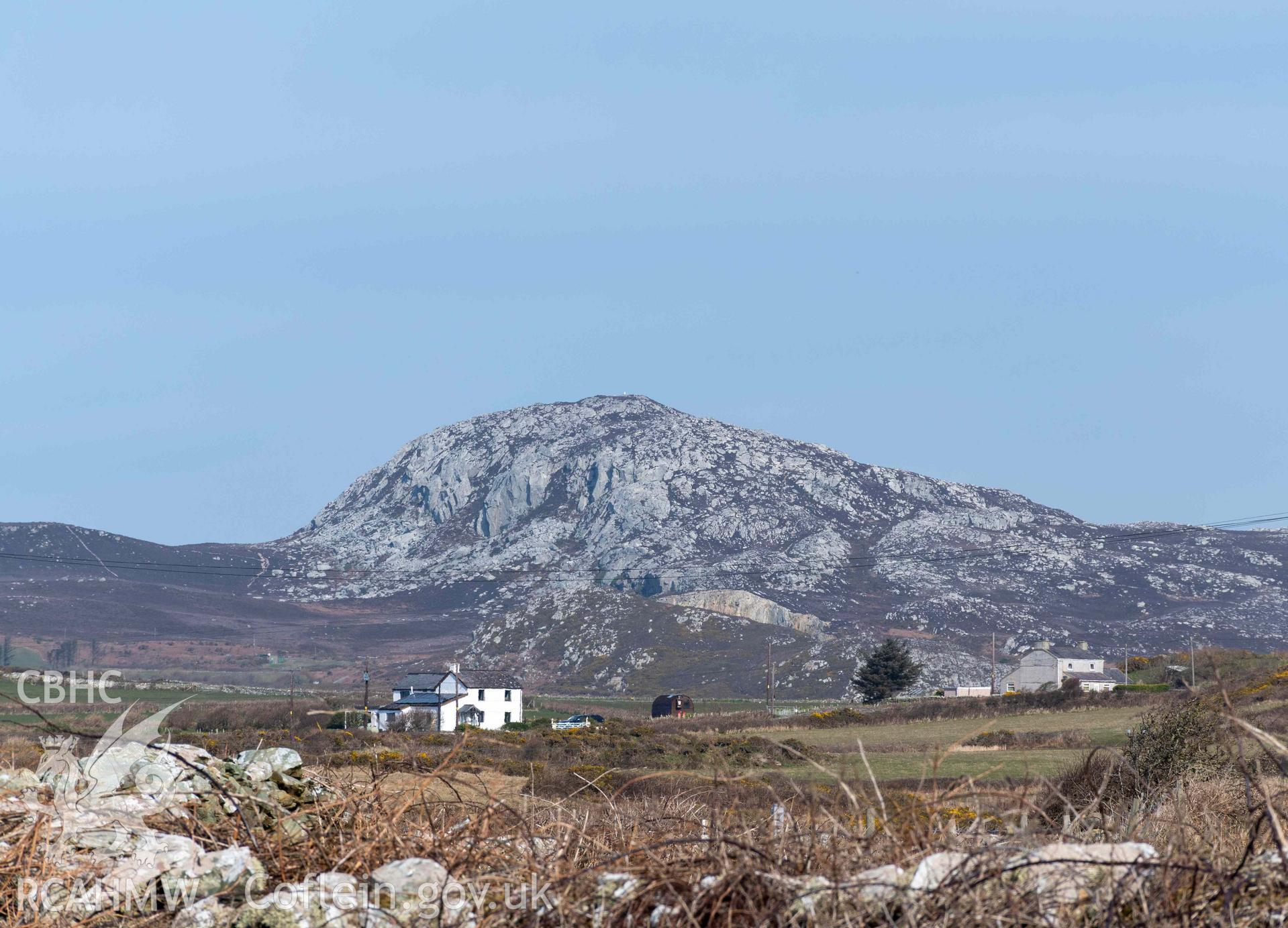 Distant view of Caer y Twr Hillfort on Holyhead Mountain from the south at South Stacks Cliffs Nature Reserve.