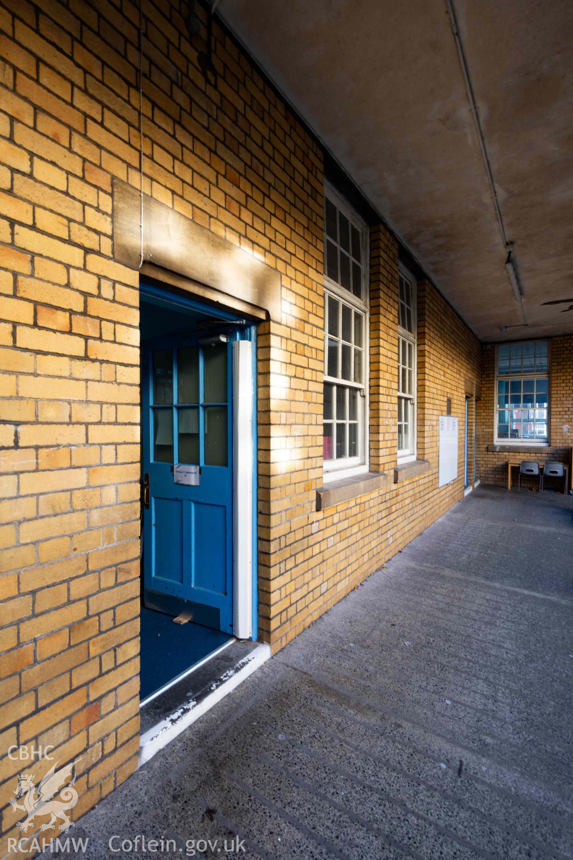 View along courtyard walkway south elevation, looking west. Classroom door open
