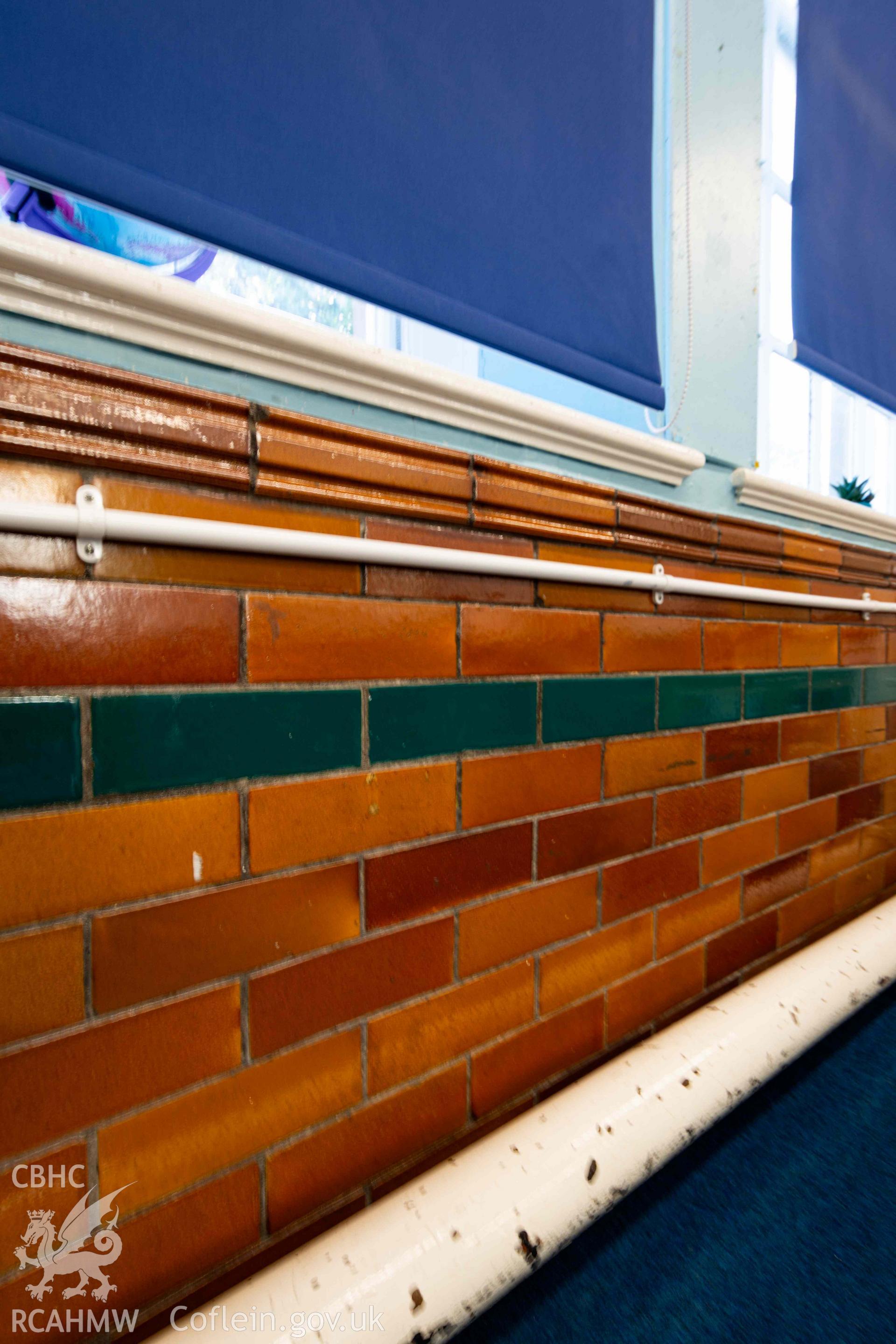 Glazed and painted brickwork on lower wall section of classroom
