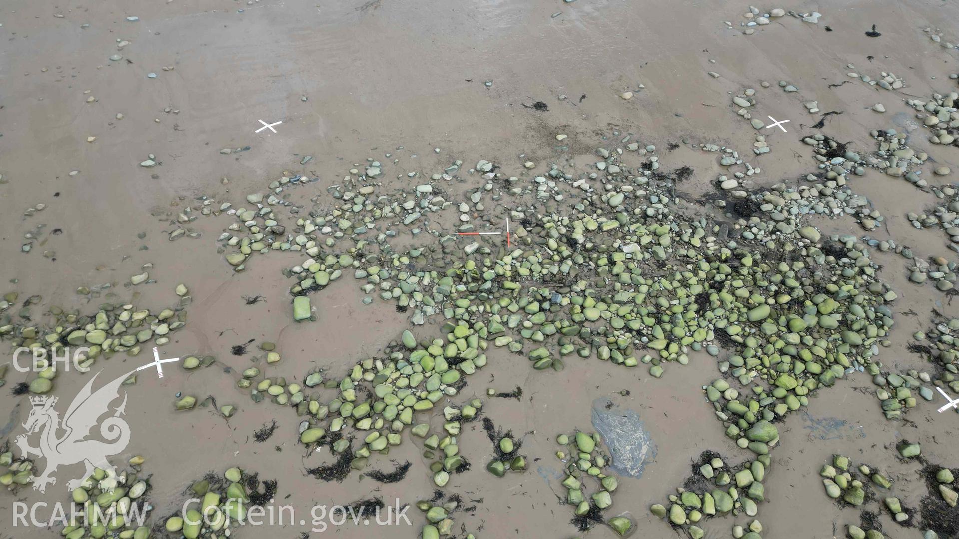 Oblique view of the shipwreck on Llandanwg Beach, looking east on 28/03/2025, scales are 1m.