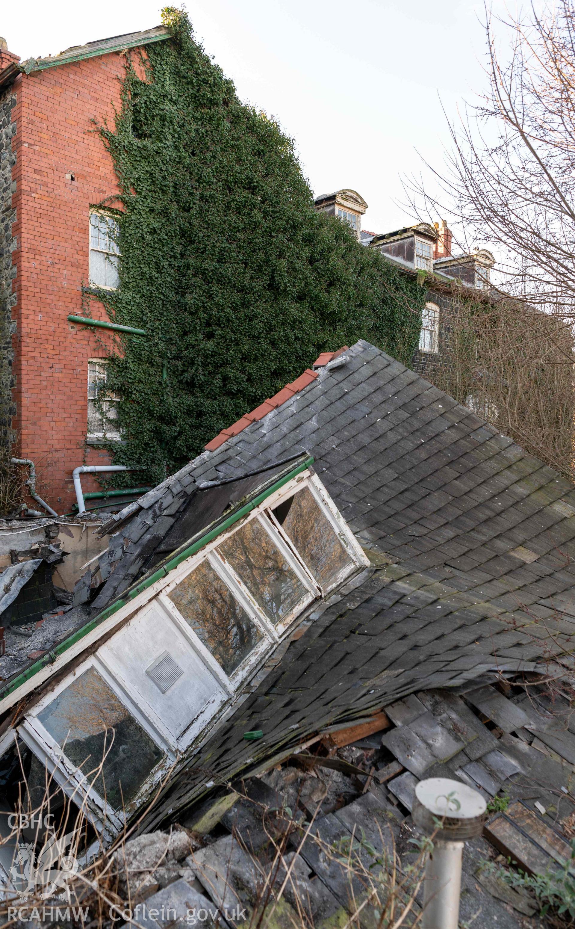 Corbett Arms Hotel, exterior rear of hotel, collapsed roof of rear extension of 22 Maengwyn Street from south-east