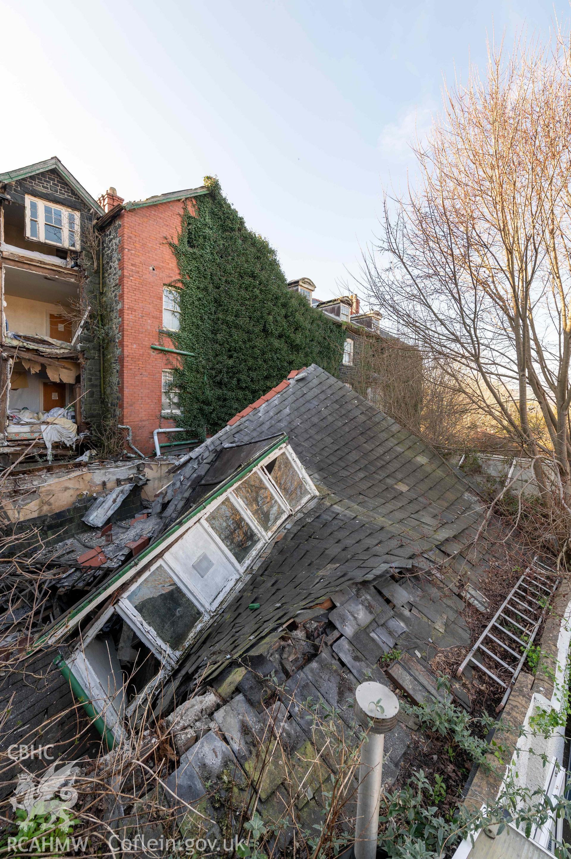 Corbett Arms Hotel, exterior rear of hotel, collapsed roof of rear extension of 22 Maengwyn Street from south-east
