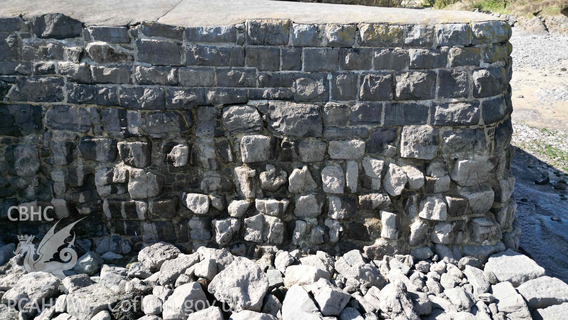 Detail of the eastern side of the breakwater end, at Stackpole Quay on 31/03/2025, showing the transition between building phases visible within the wall elevation.