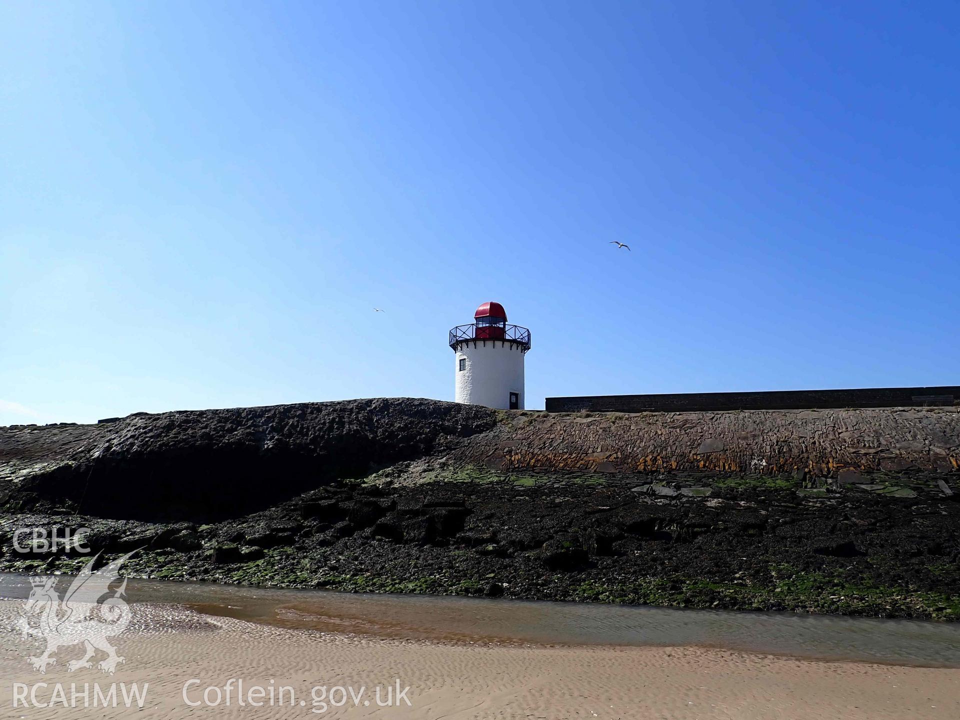 Burry Port Lighthouse, viewed from the beach on the eastern side of the breakwater, on 01/04/2025.